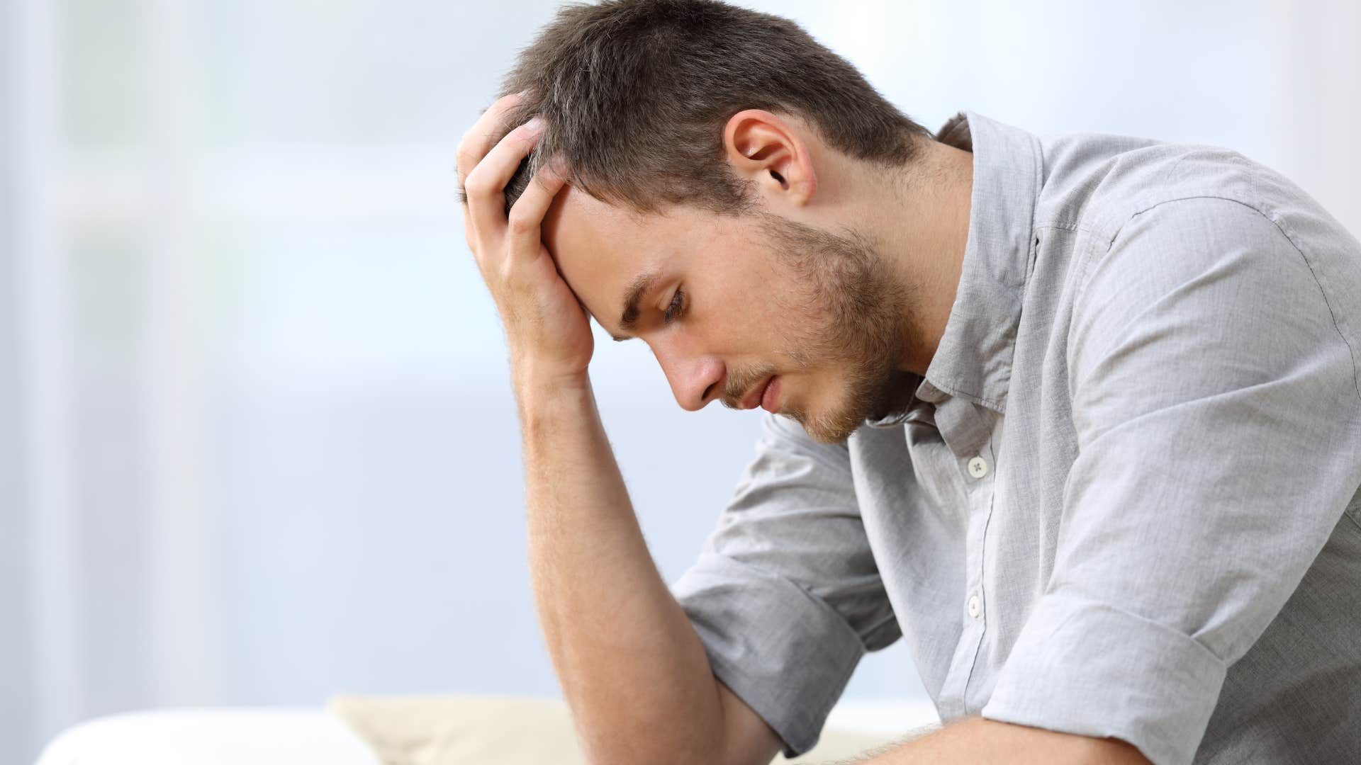 man thinking I want affection while holding his head