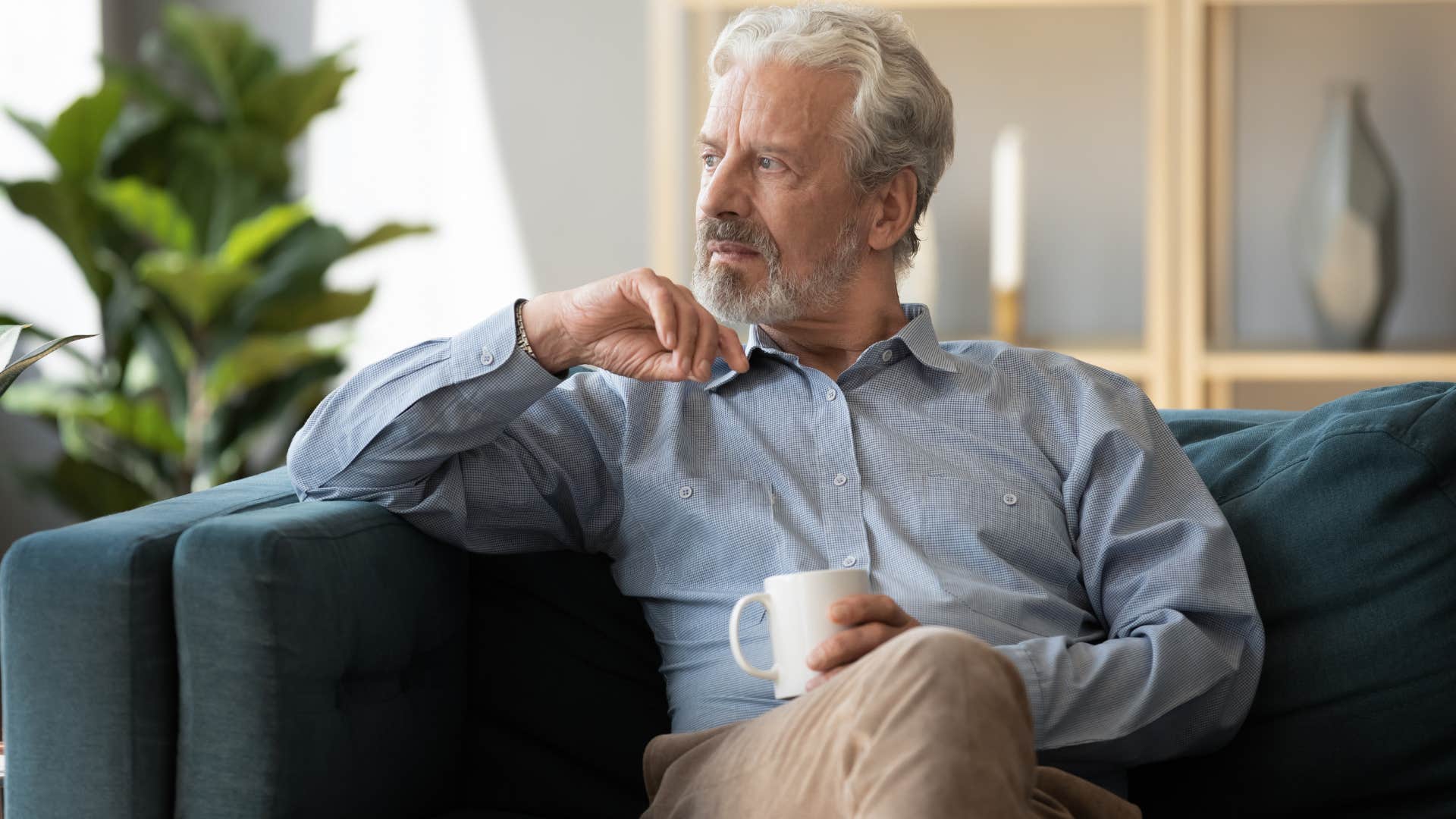 Man whose values have changed sitting on the couch.