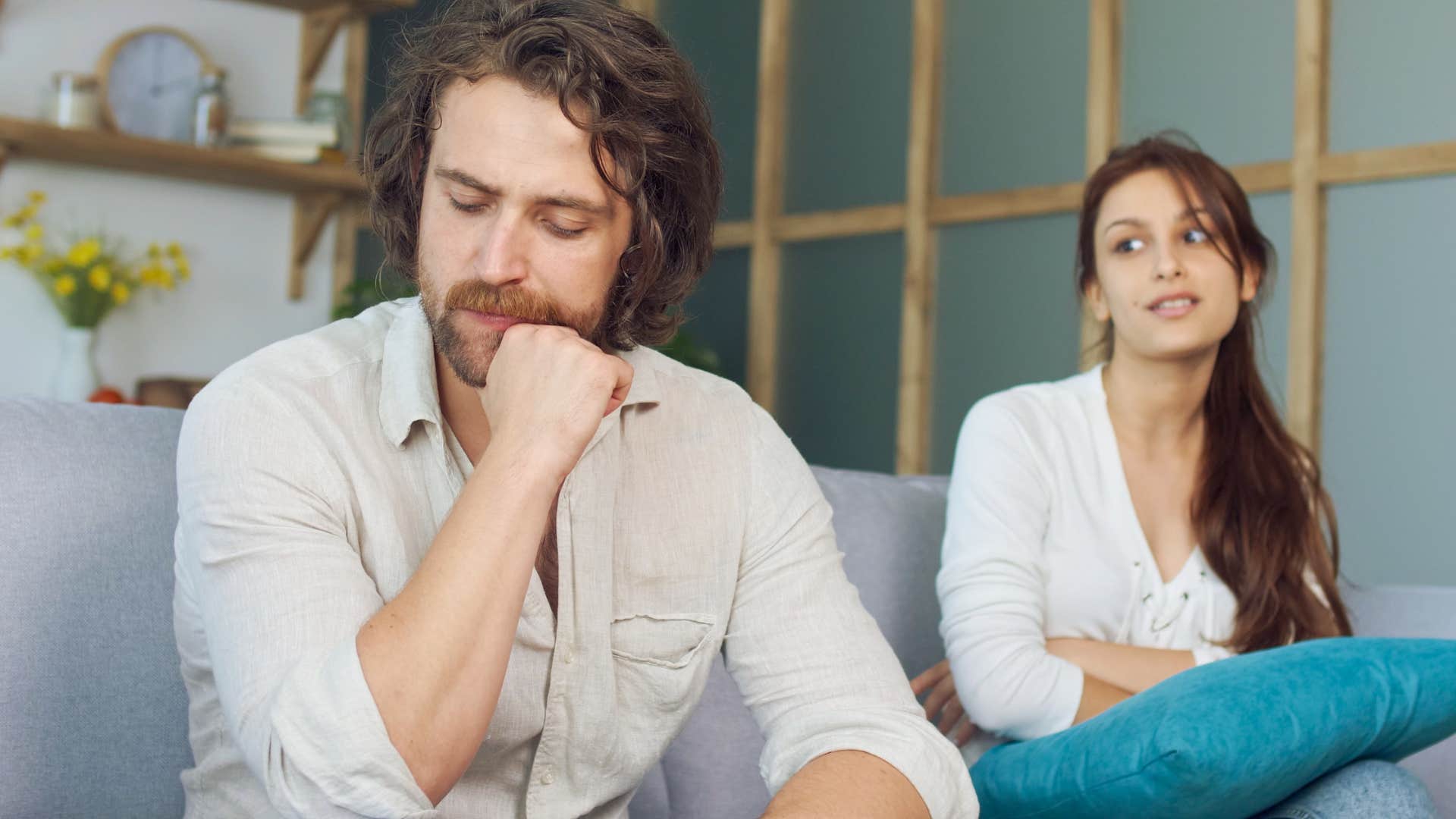 Upset man saying "you deserve someone better" to his upset wife.