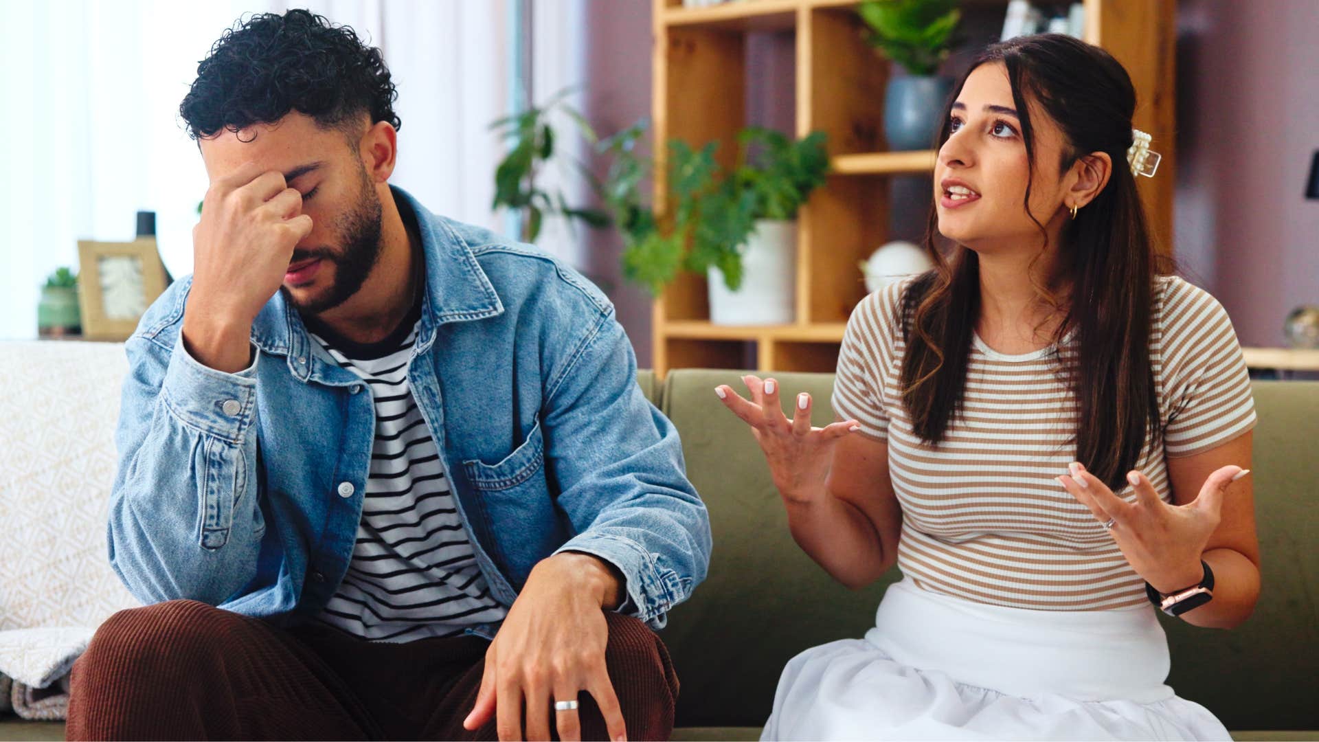 Man saying "I don't care anymore" to his upset wife.