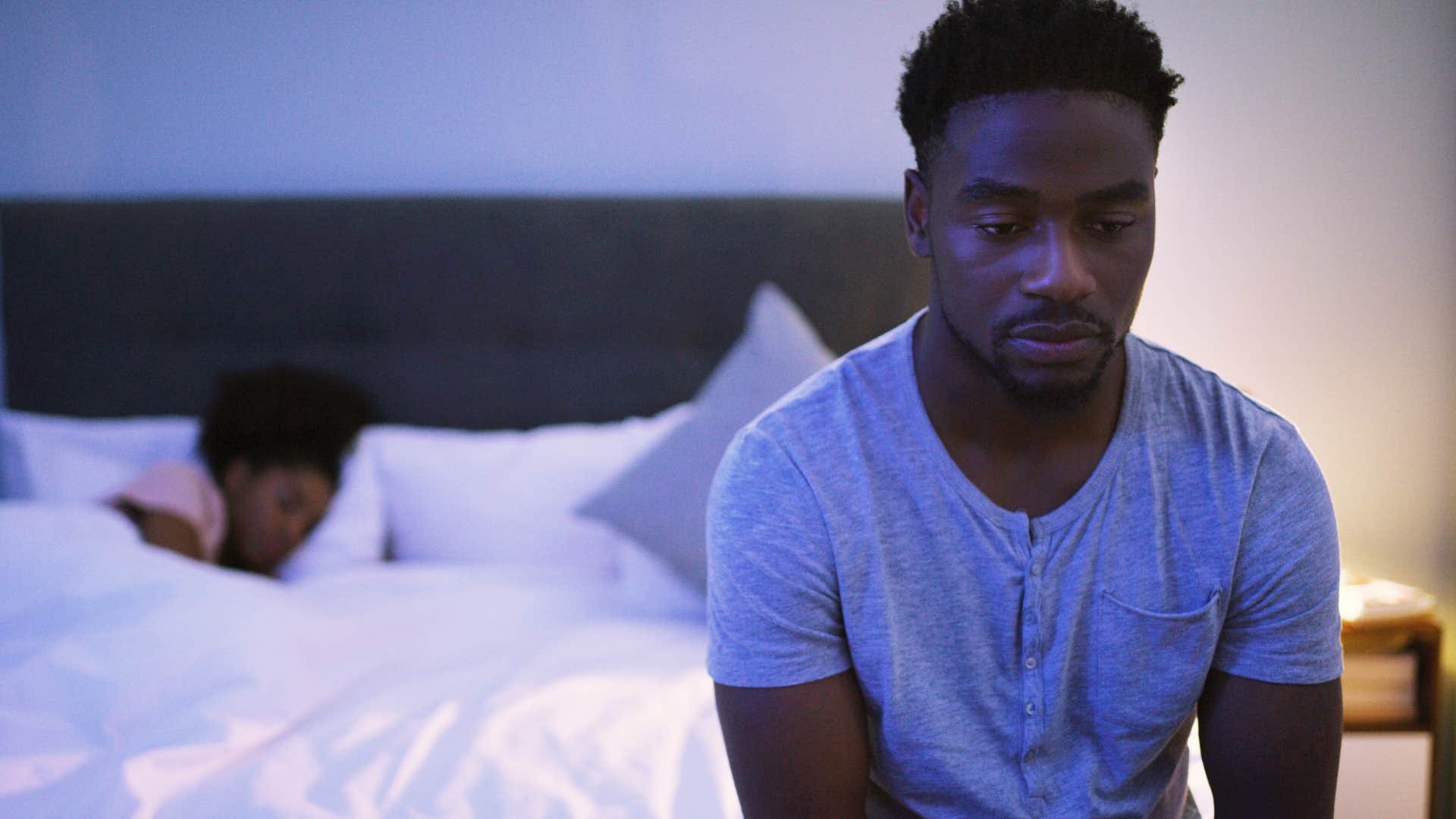 Man saying "I'm too tired" to his wife at night.