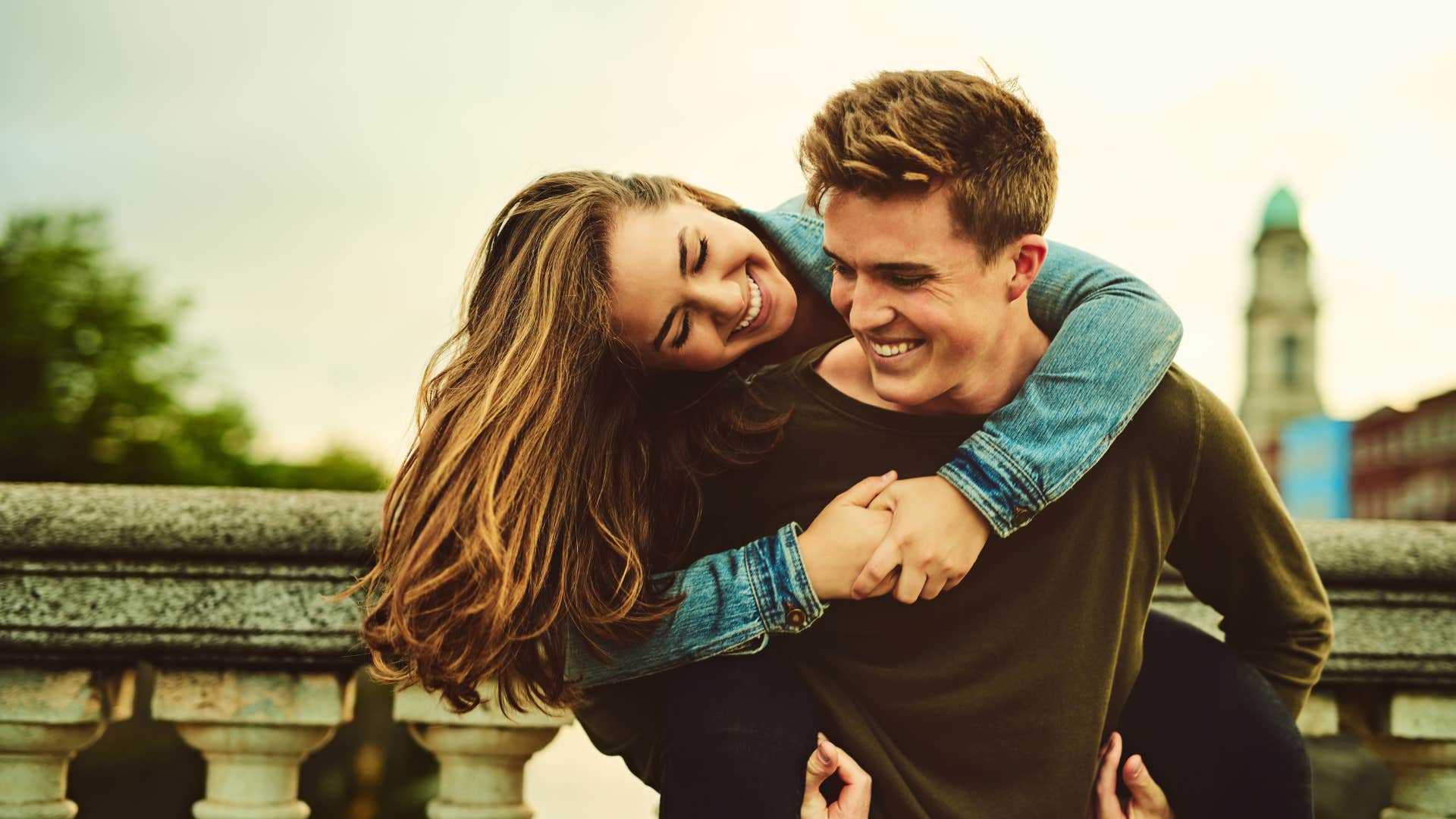 man holding woman on back