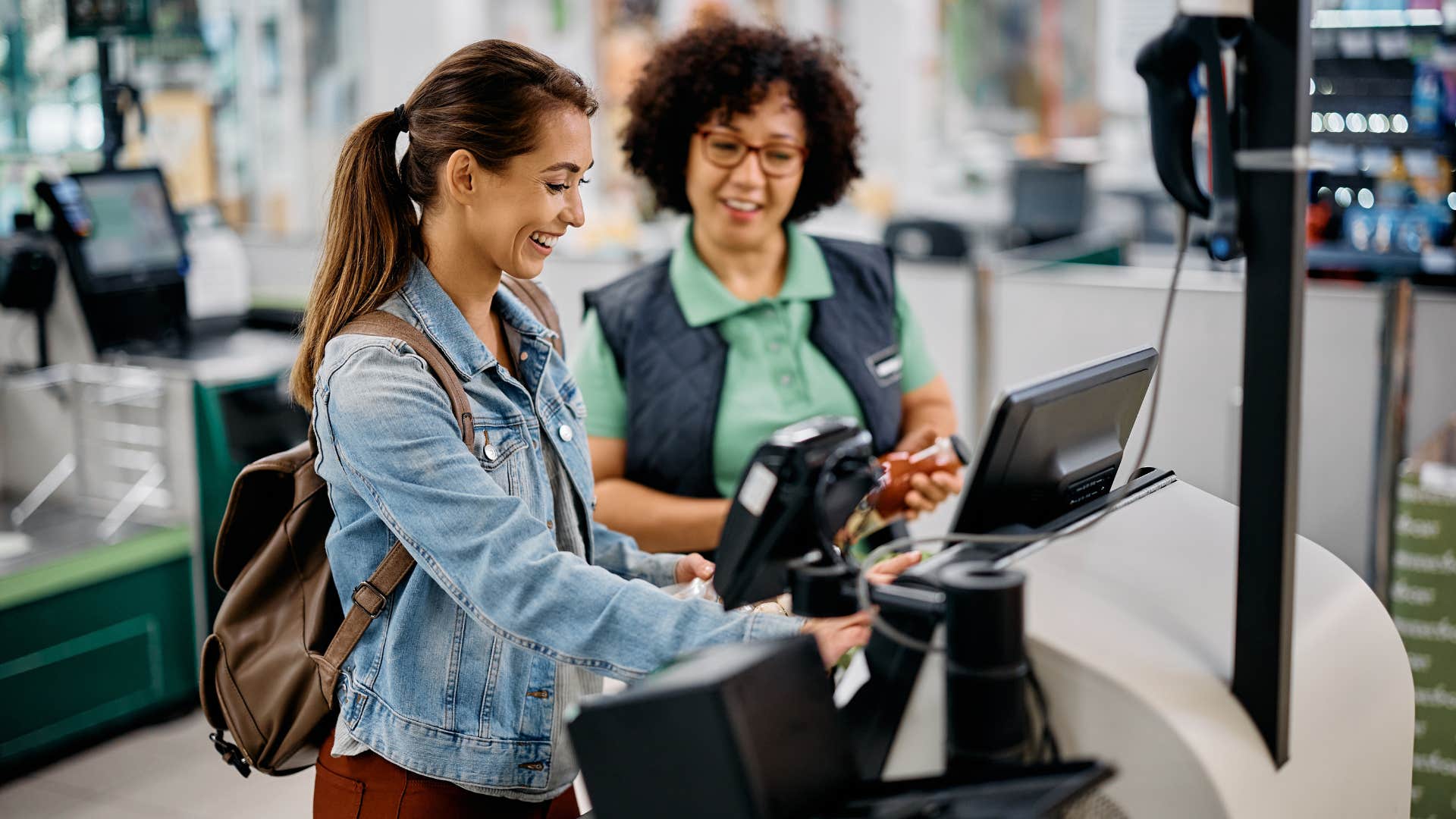 woman using self-checkout at the store