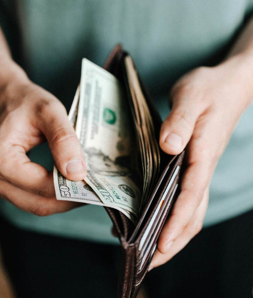 kind stranger getting money out of his wallet to give away