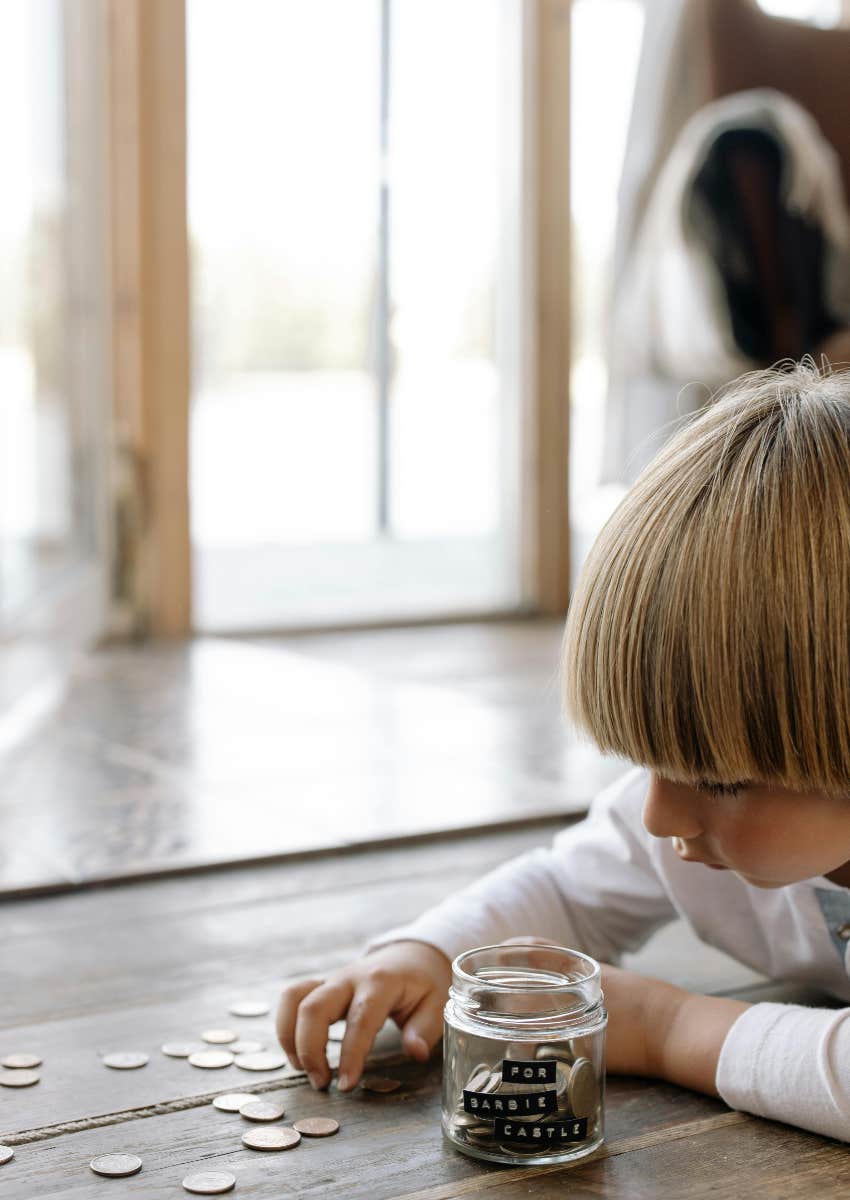 young child learning how to save money