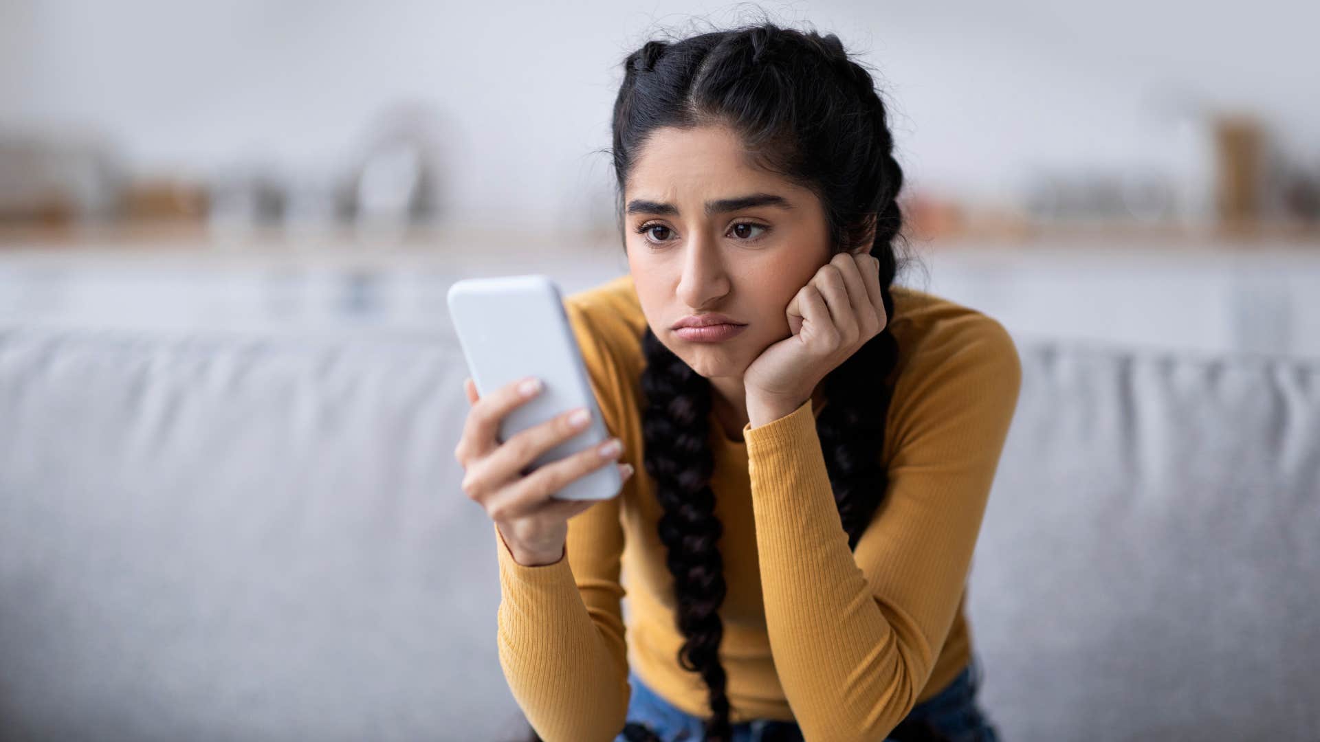 woman in yellow shirt always being the one to reach out first as she looks upset