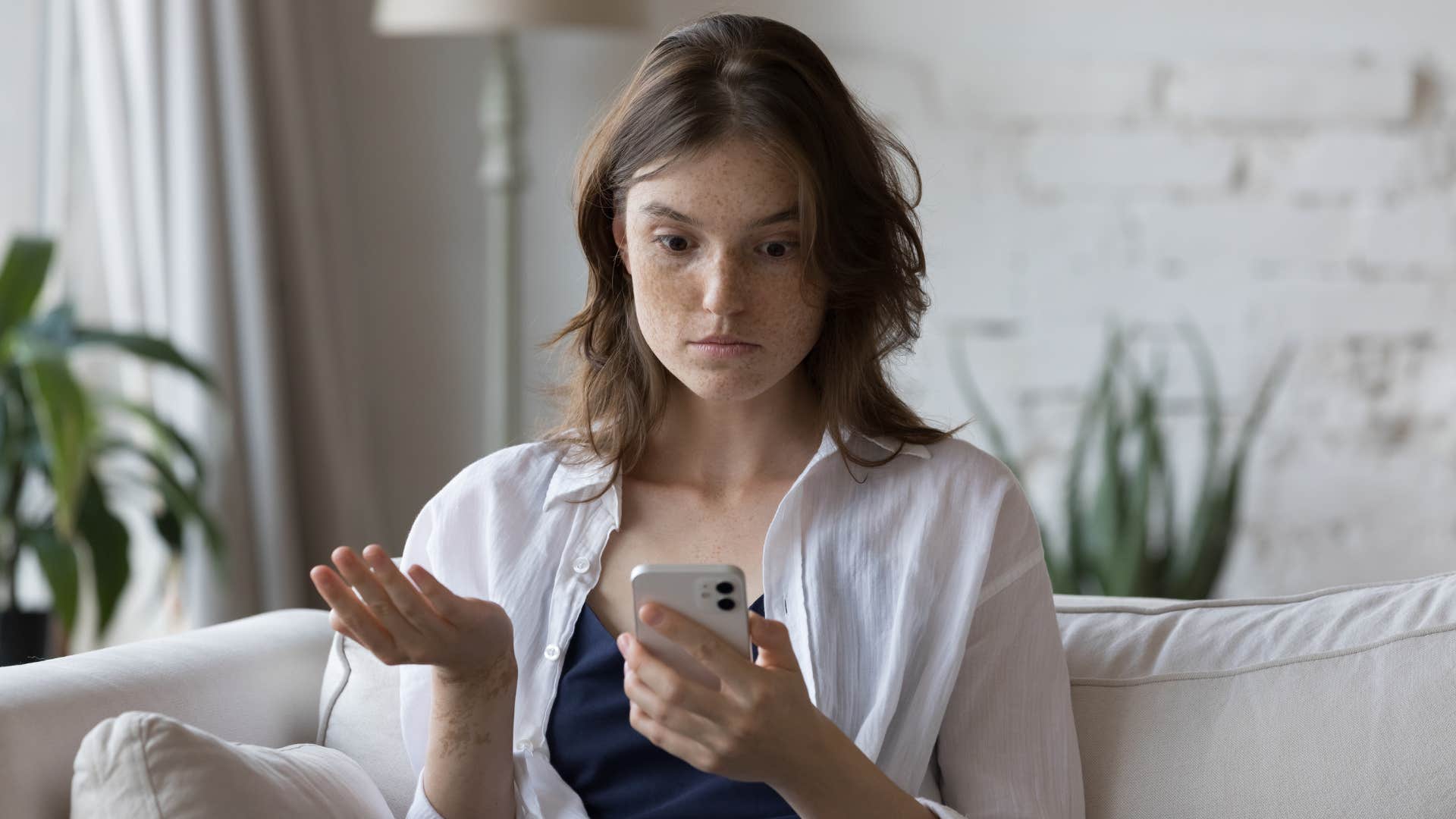 woman with white shirt upset as friend breaks a promise she was counting on