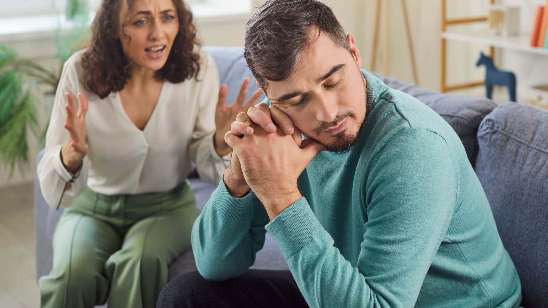 man being mocked by his wife at home