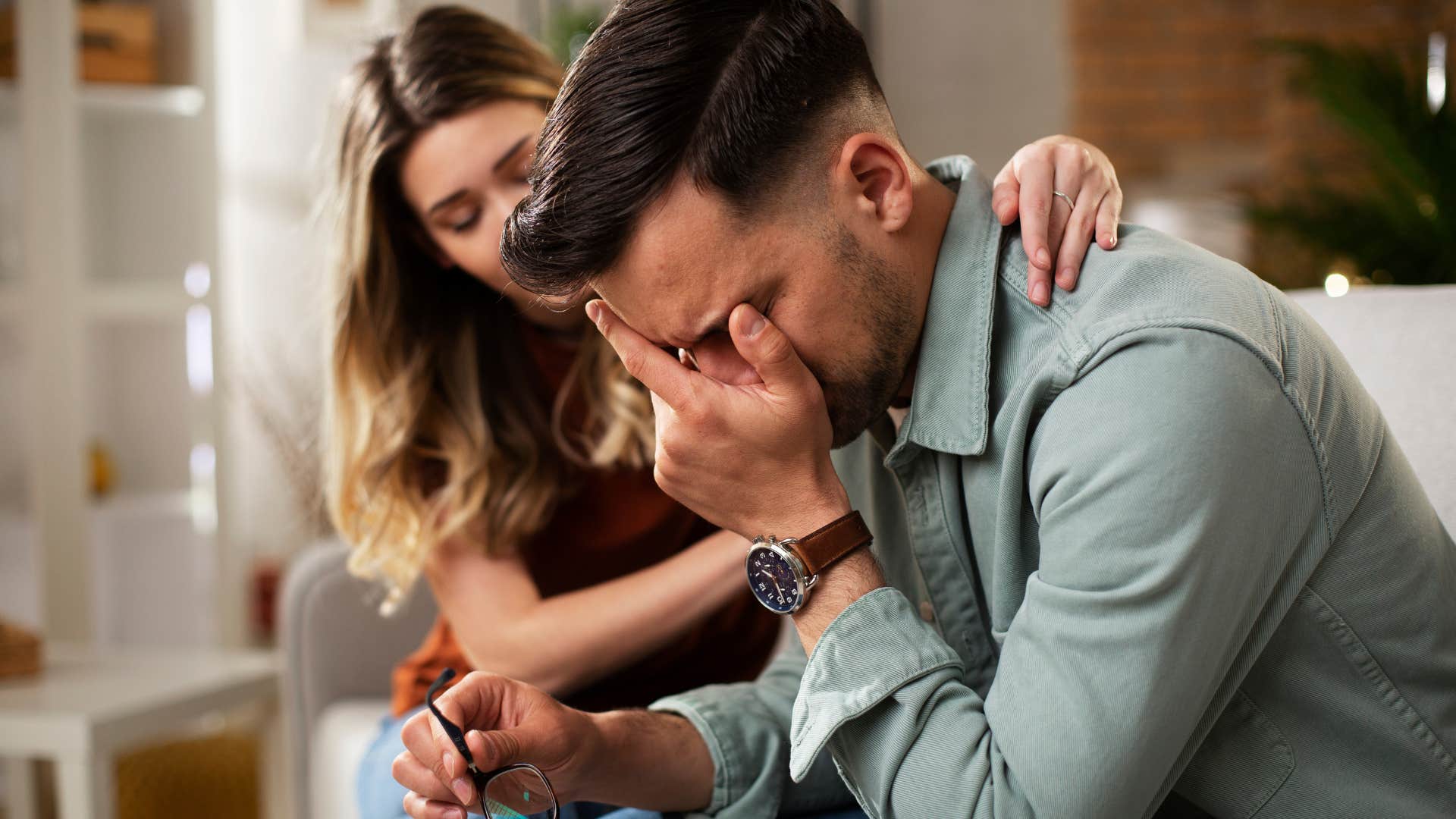 man feeling rejected being comforted by his wife