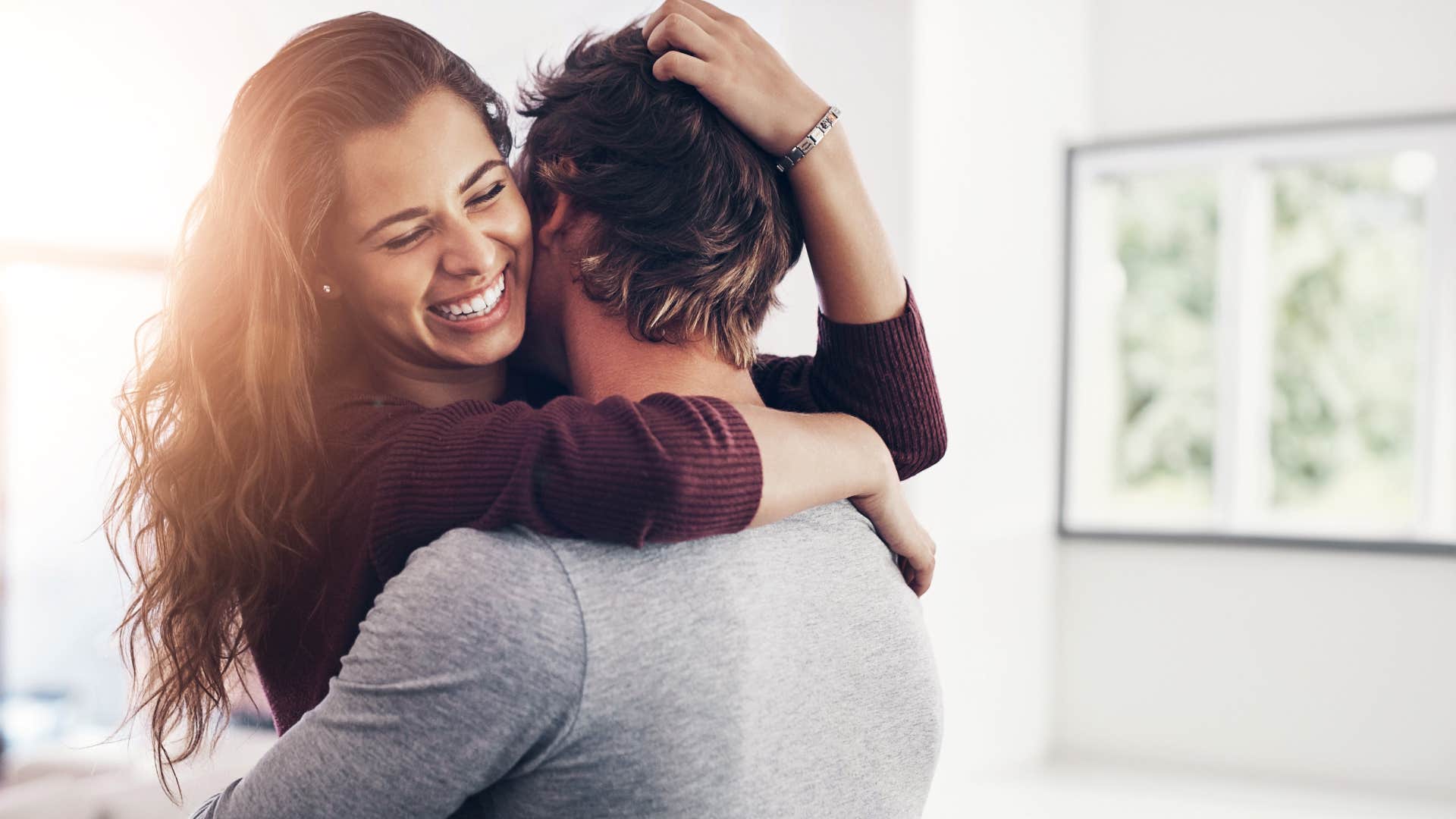 woman has a dramatic streak as she hugs man and smiles
