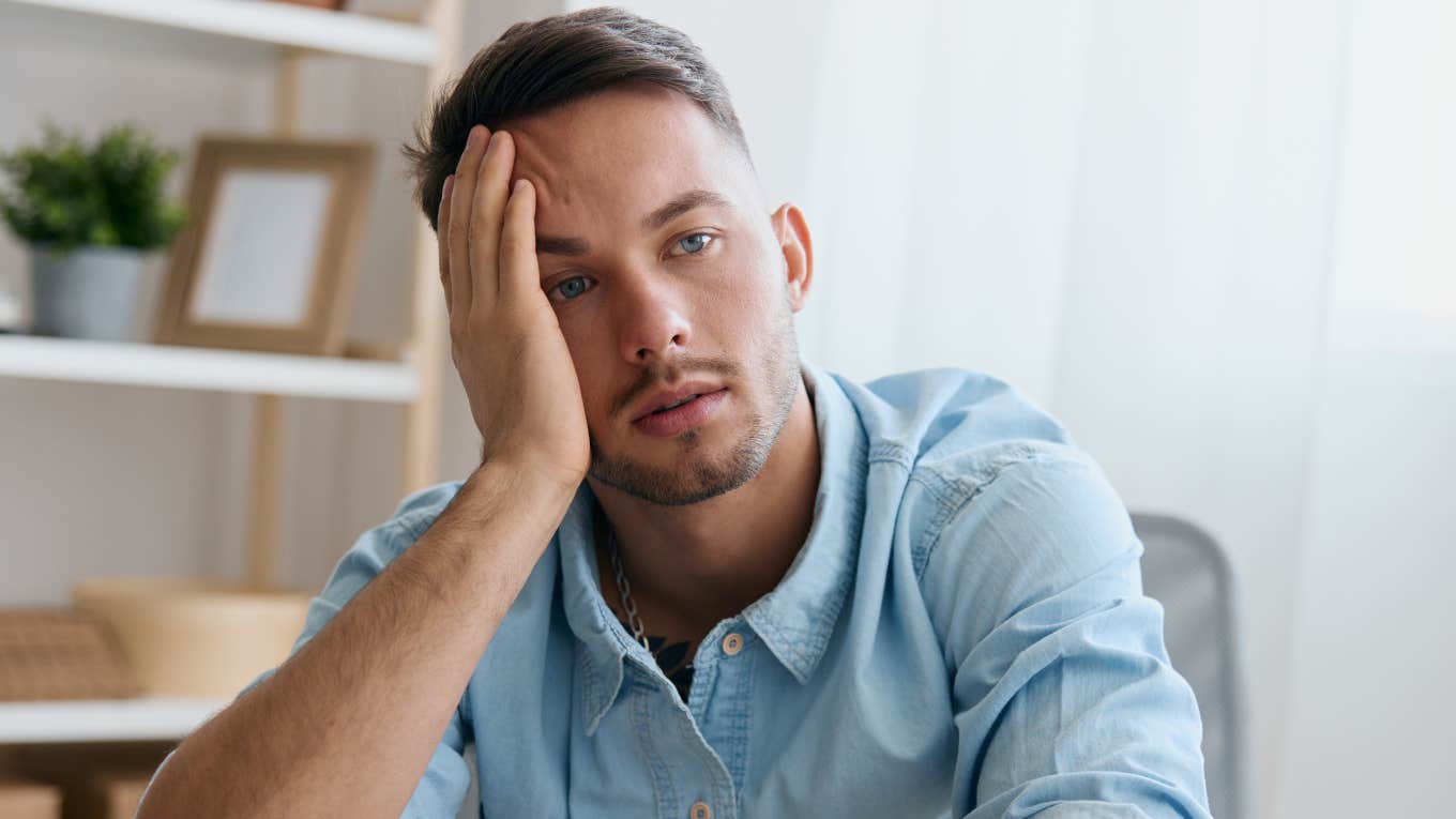If You Notice These Things At A Man's House, He's Struggling More Than He Admits sad man sitting at home struggling with his mental health
