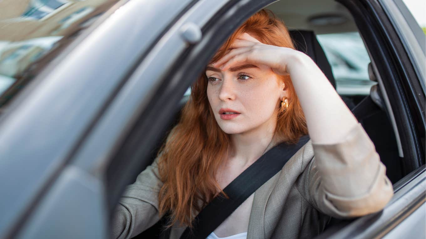 If You Notice These Things In Your Wife's Car, She's Struggling More Than She Admits sad stressed woman sitting in car behind steering wheel