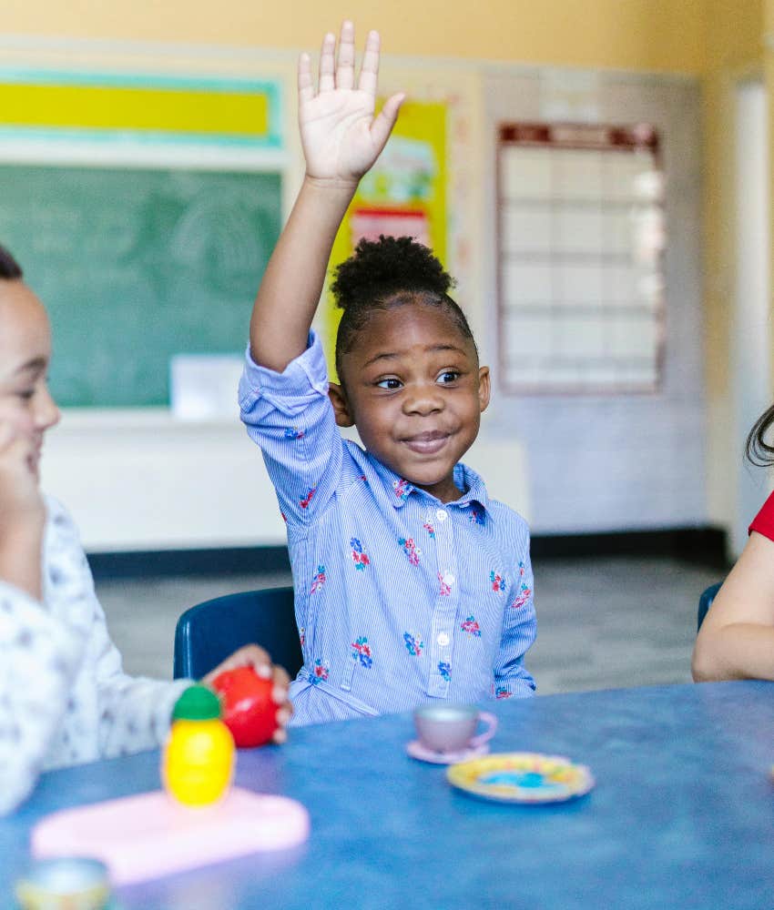 kid raising her hand in elementary school