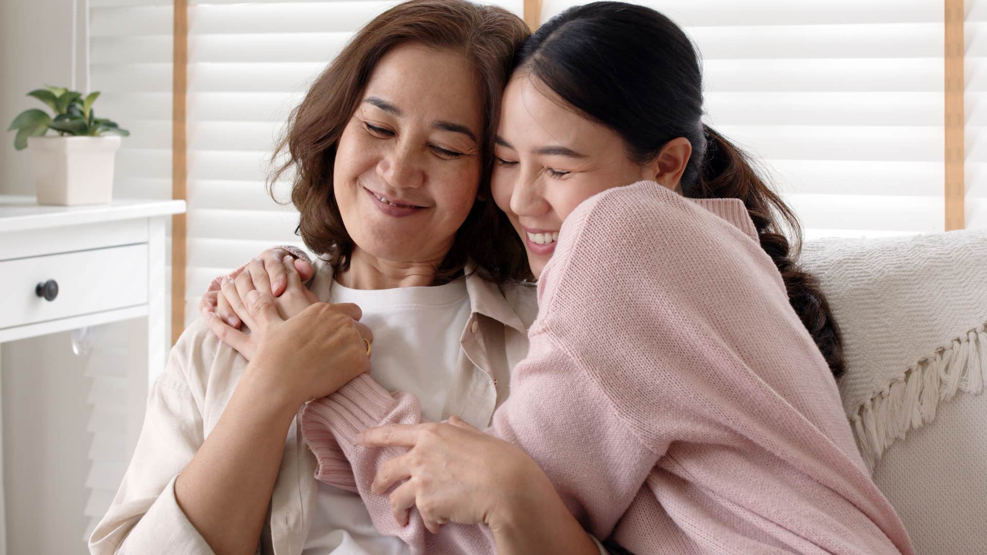 Woman hugging her mother who gives more time and attention to them.