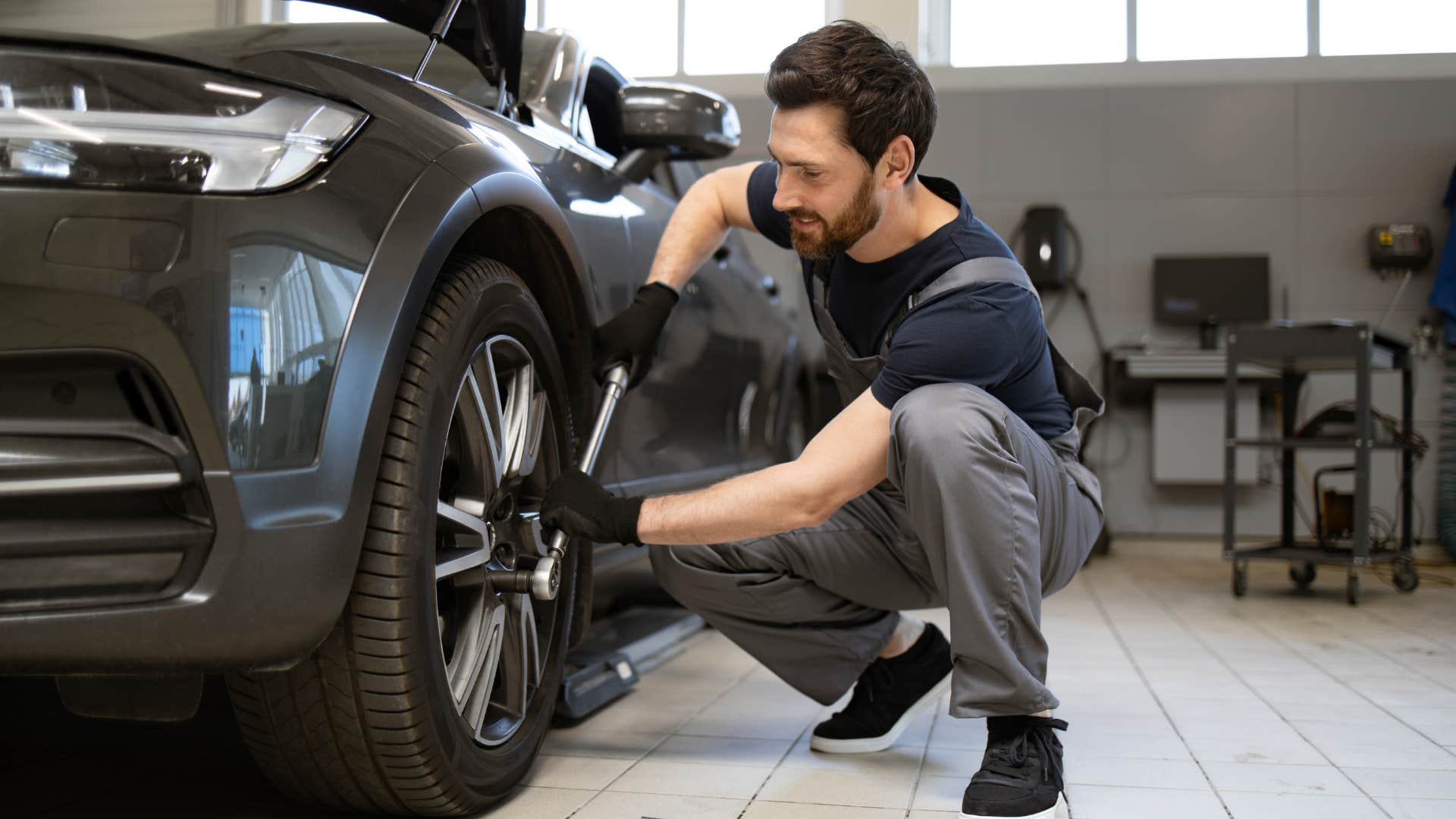 man fixing car before replacing parts