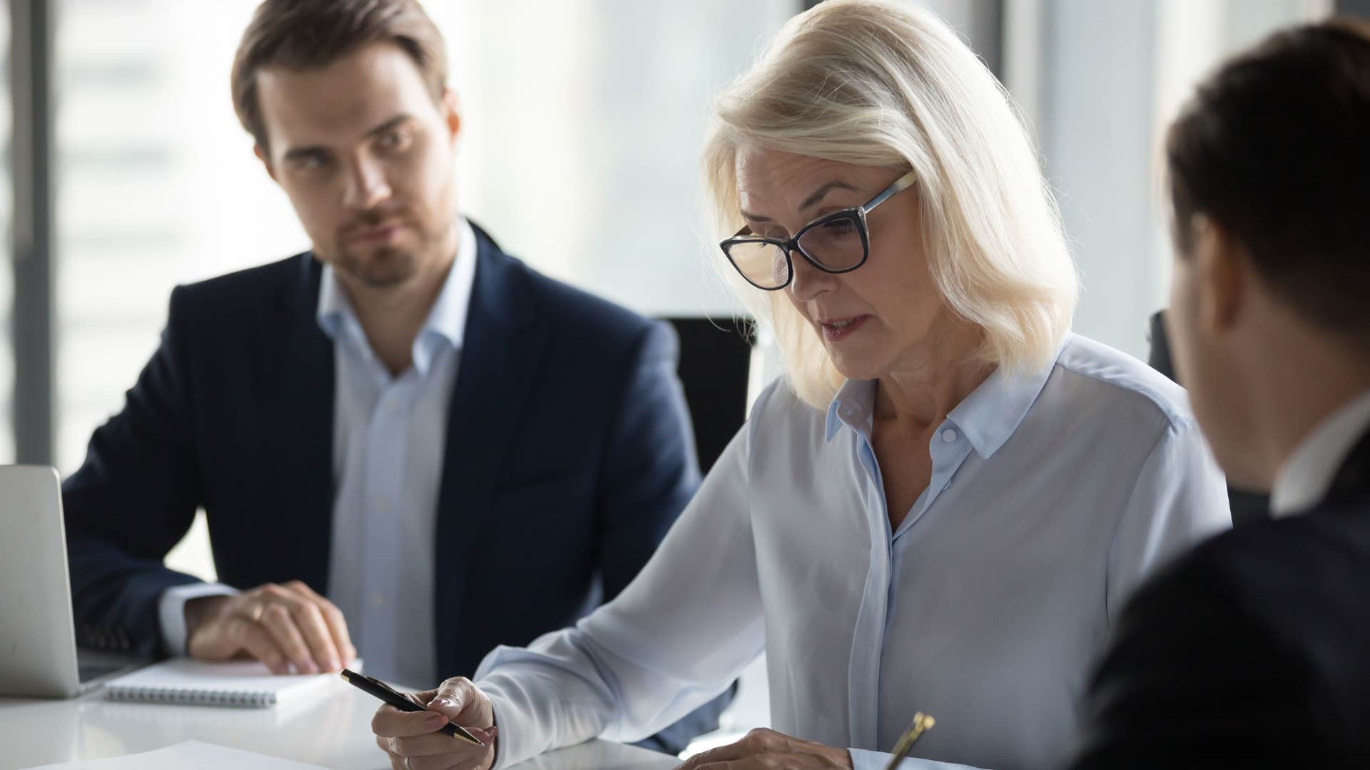 Woman saying "What are we talking about?" during a work meeting.