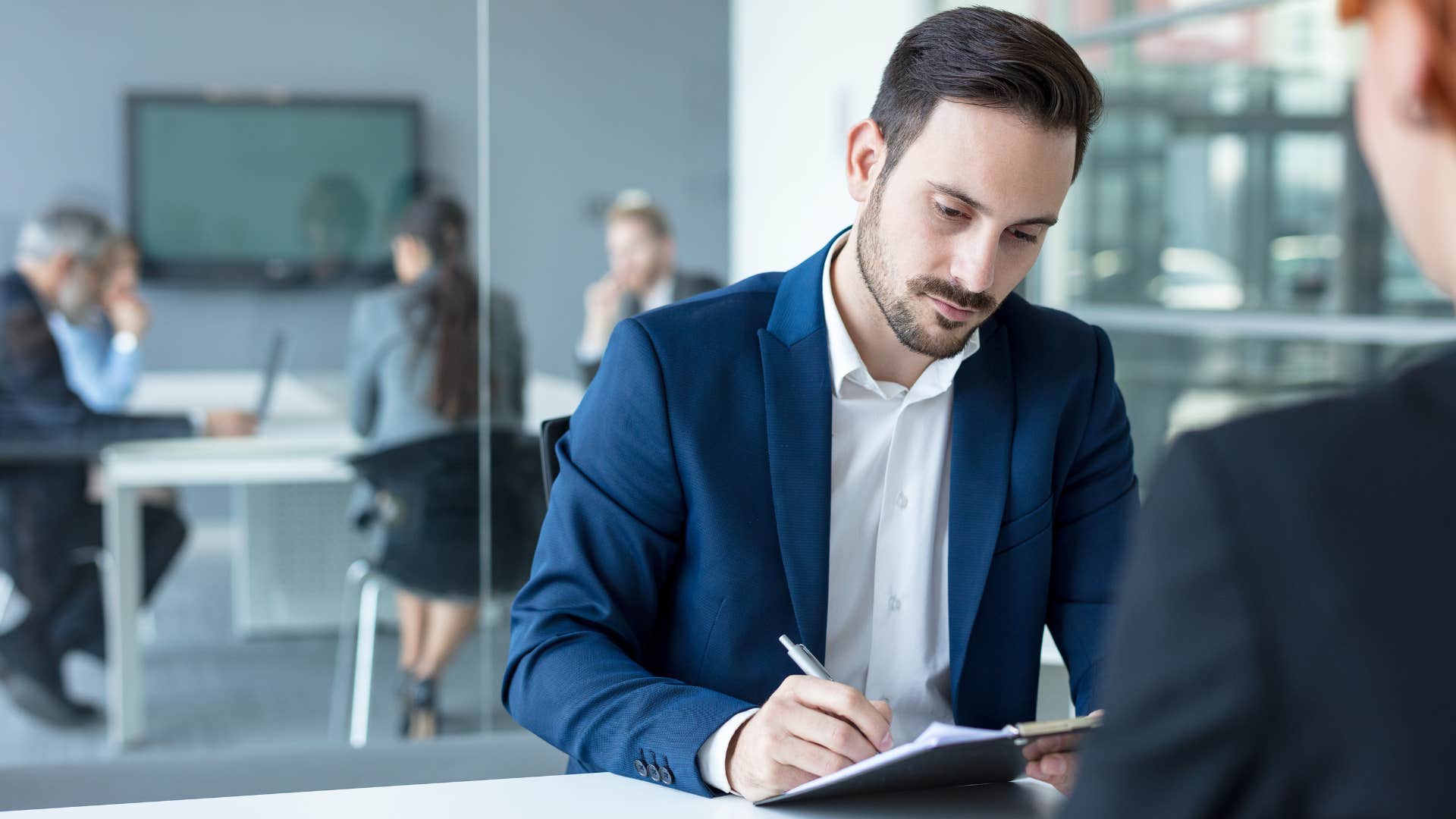 Upset man saying "whatever" during a work meeting.