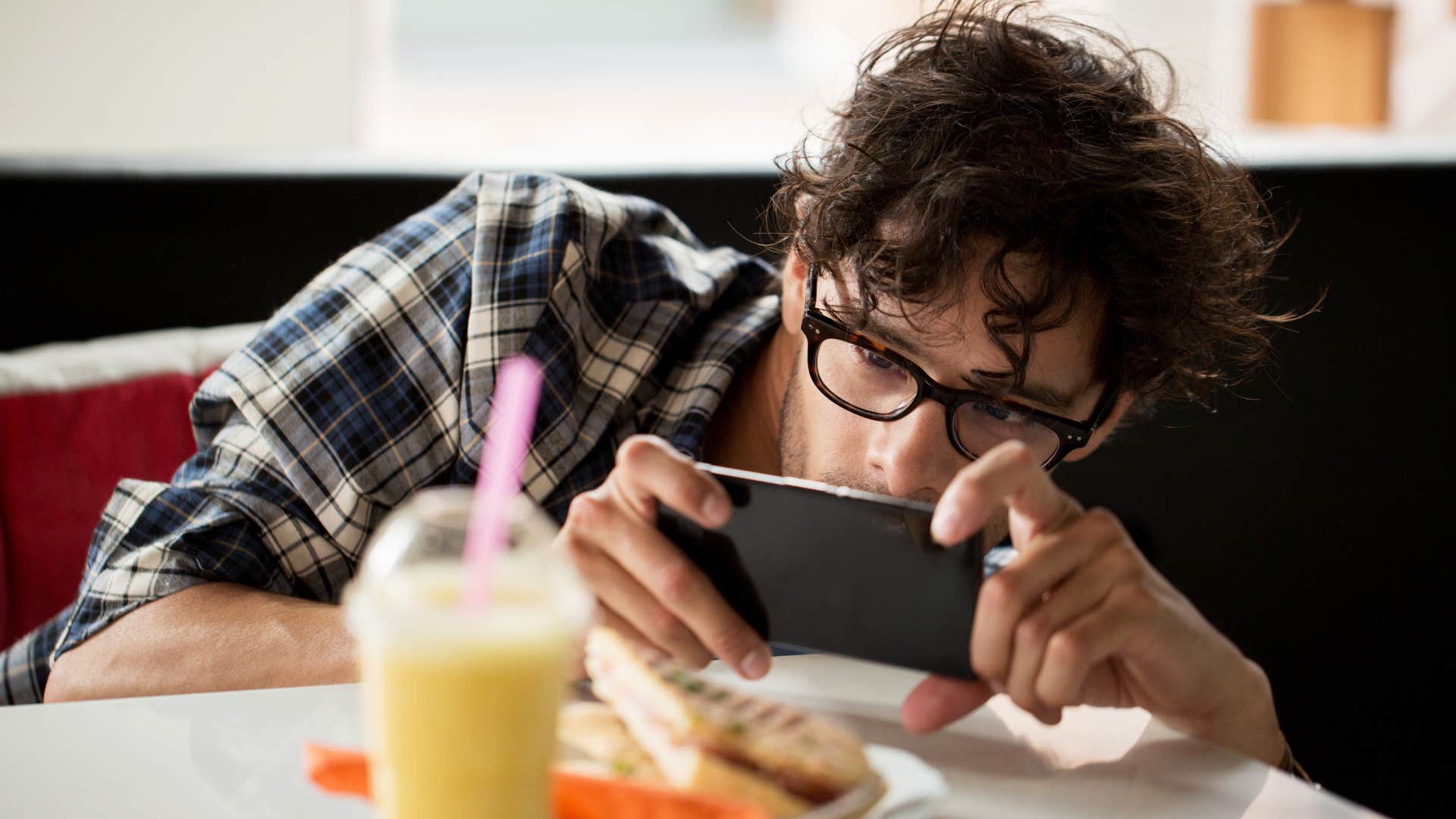 gen z man taking photo of his food