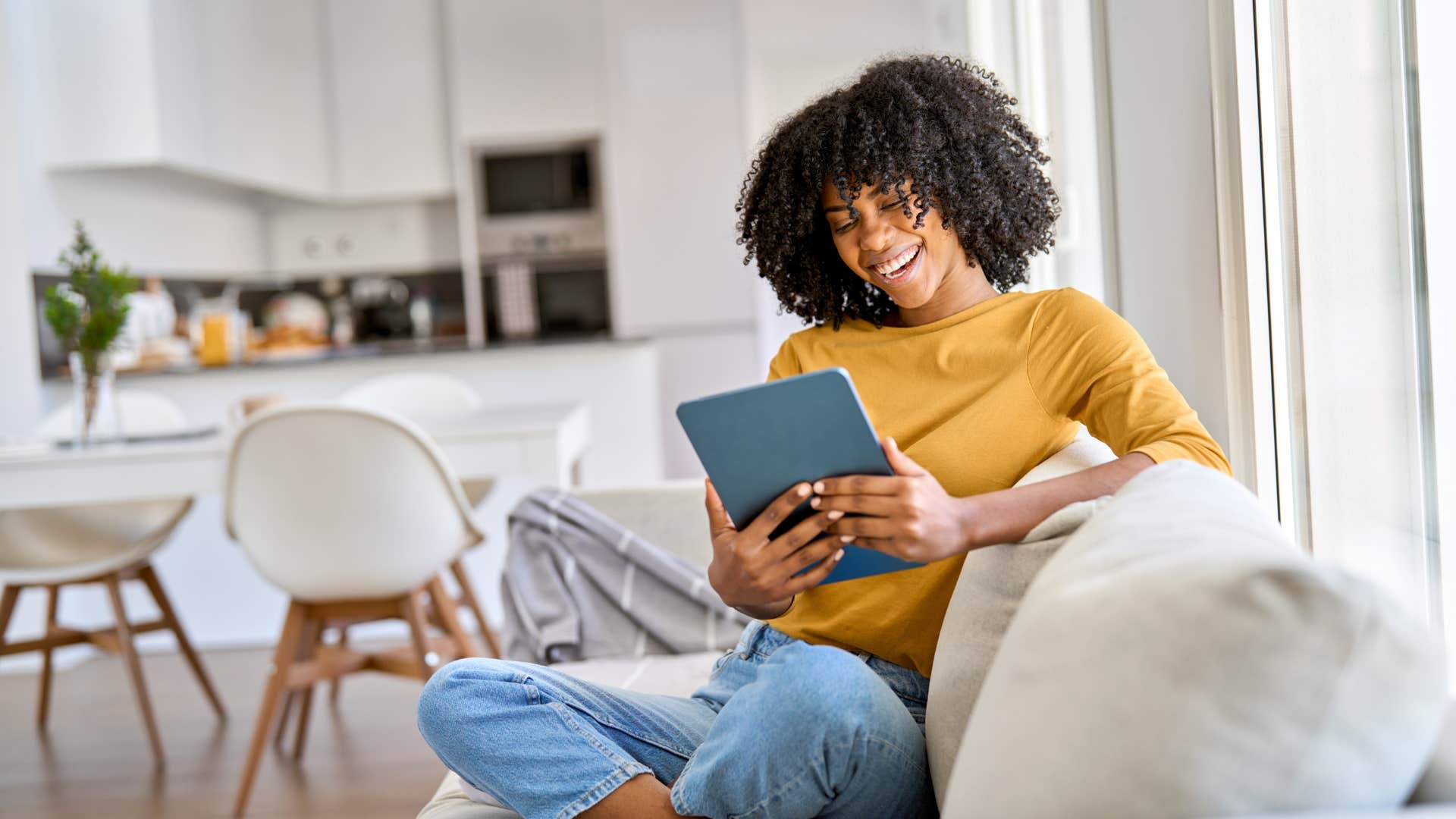 woman reading book on tablet