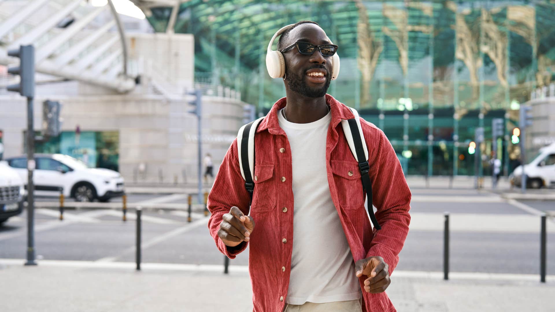 man wearing headphones walking outside