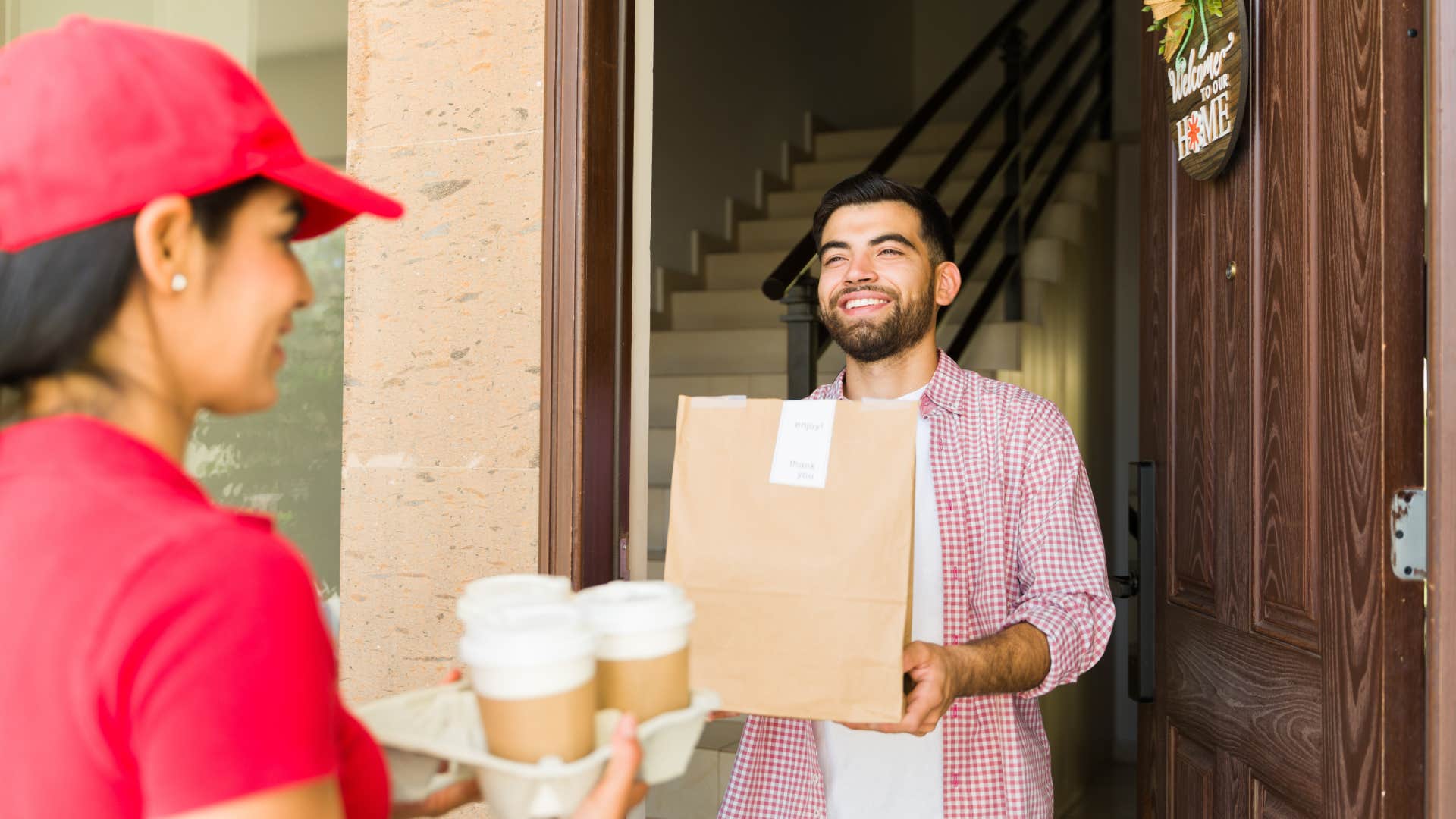 man getting food delivered to his home