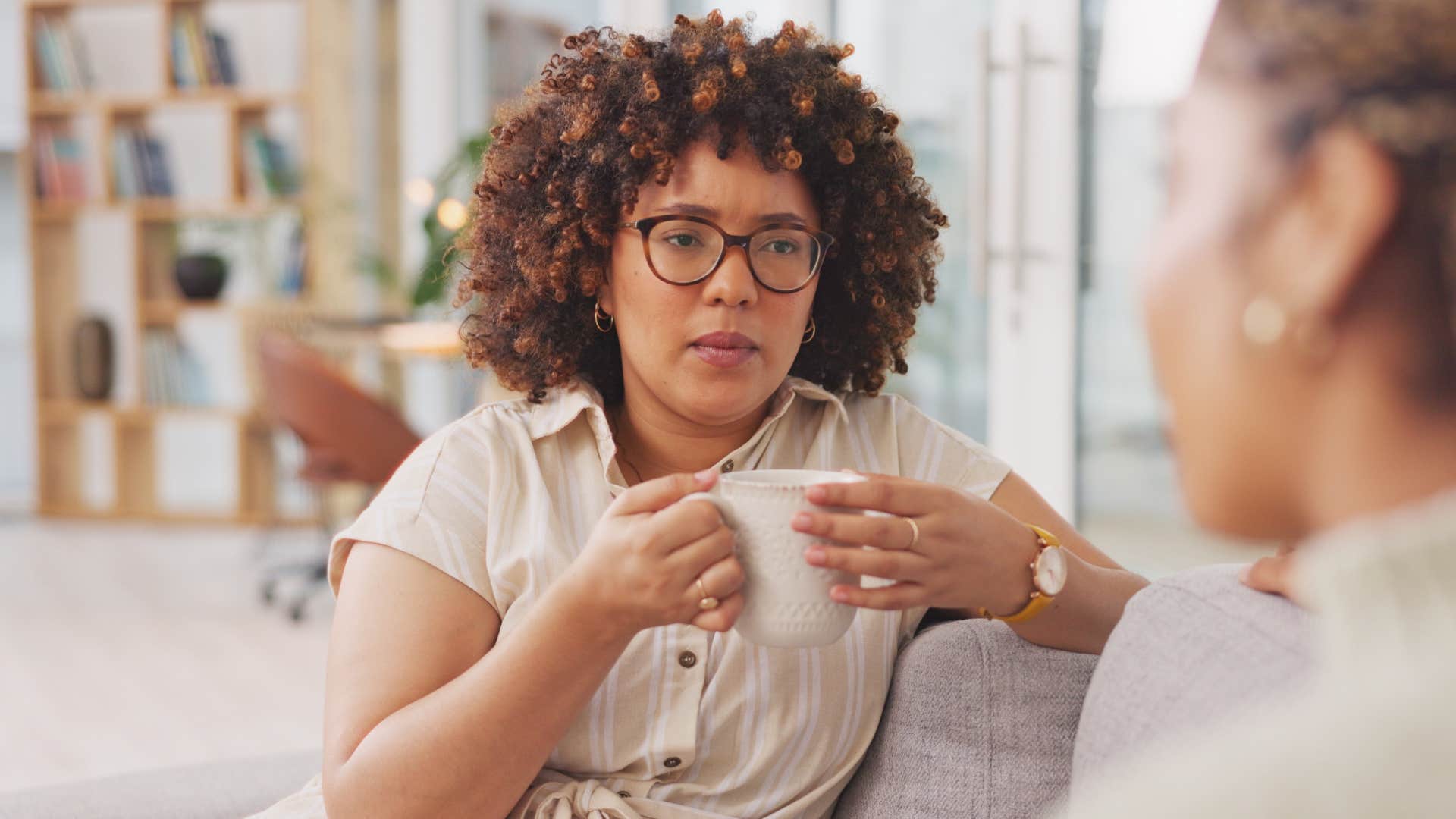Woman saying "I'll figure it out later" to her friend on a couch.