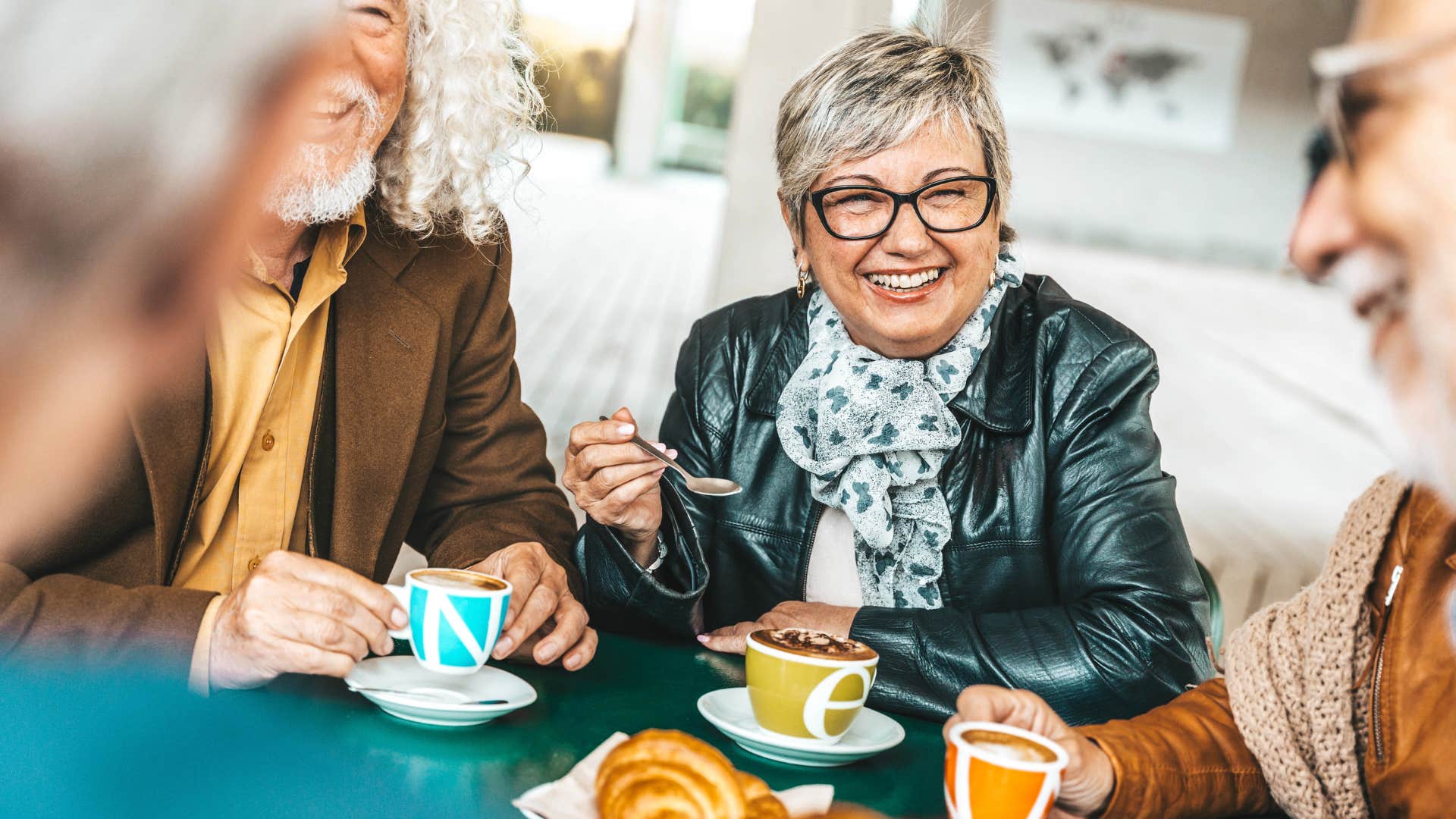 Woman smiling and saying "you only live once" with friends.