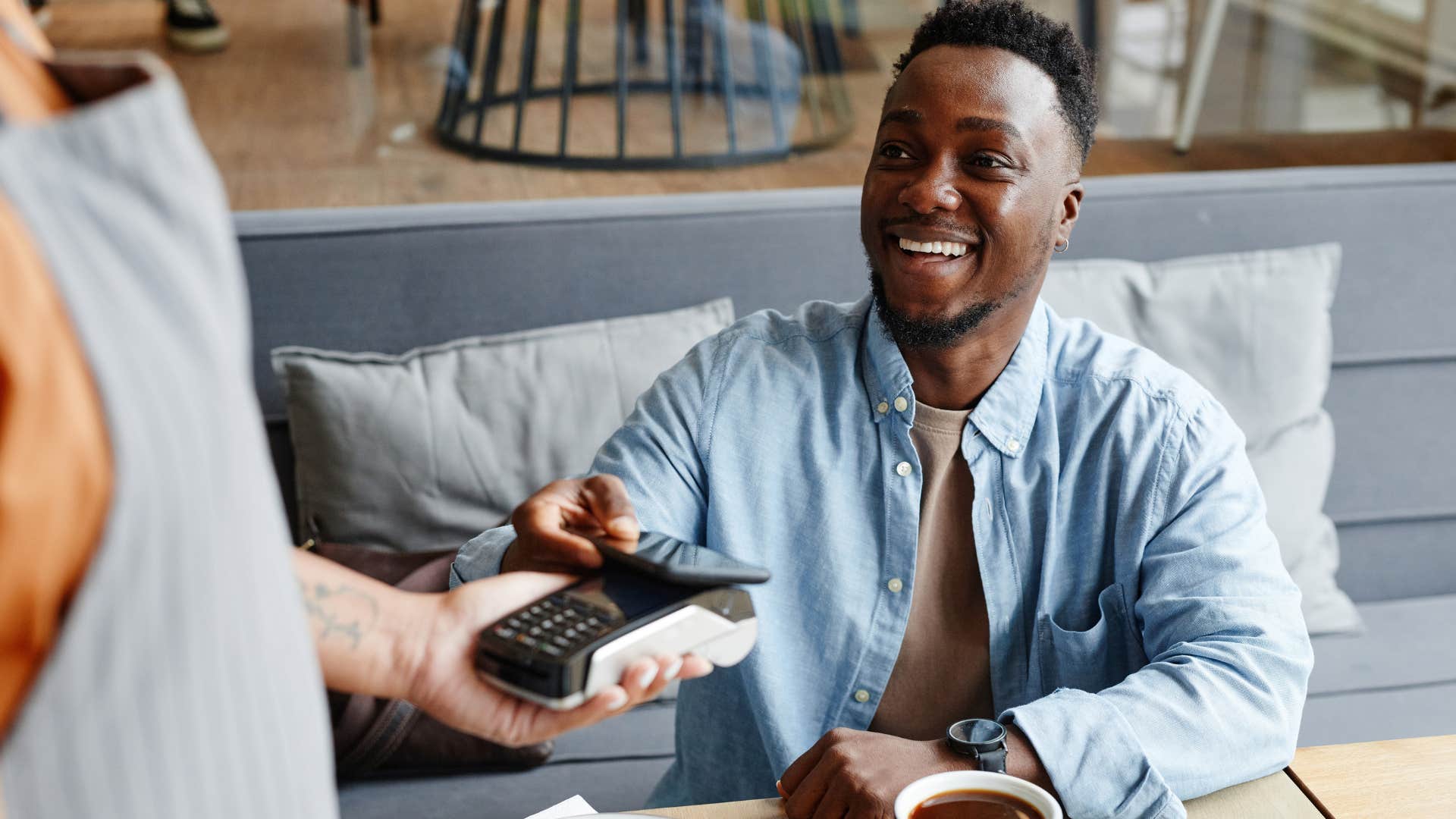 Man covering the bill in a restaurant.