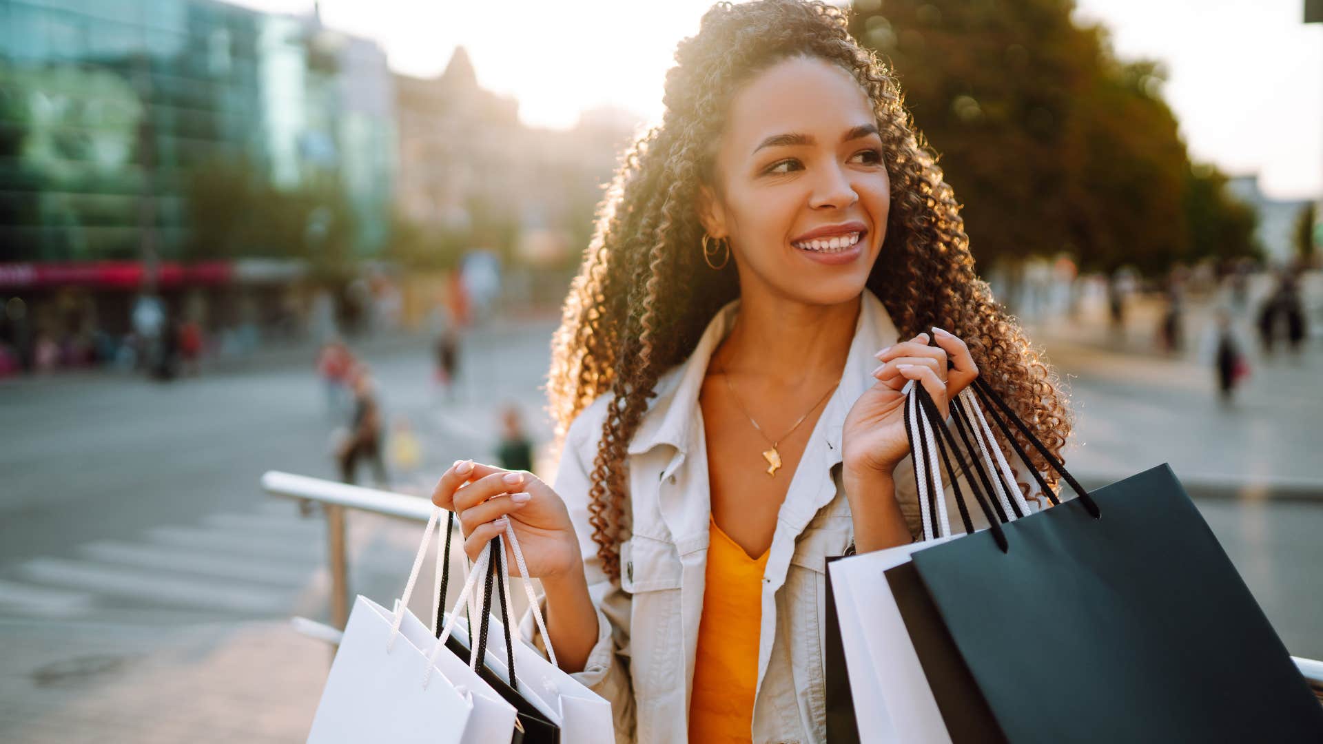 Woman experiencing lifestyle creep while shopping for clothes.