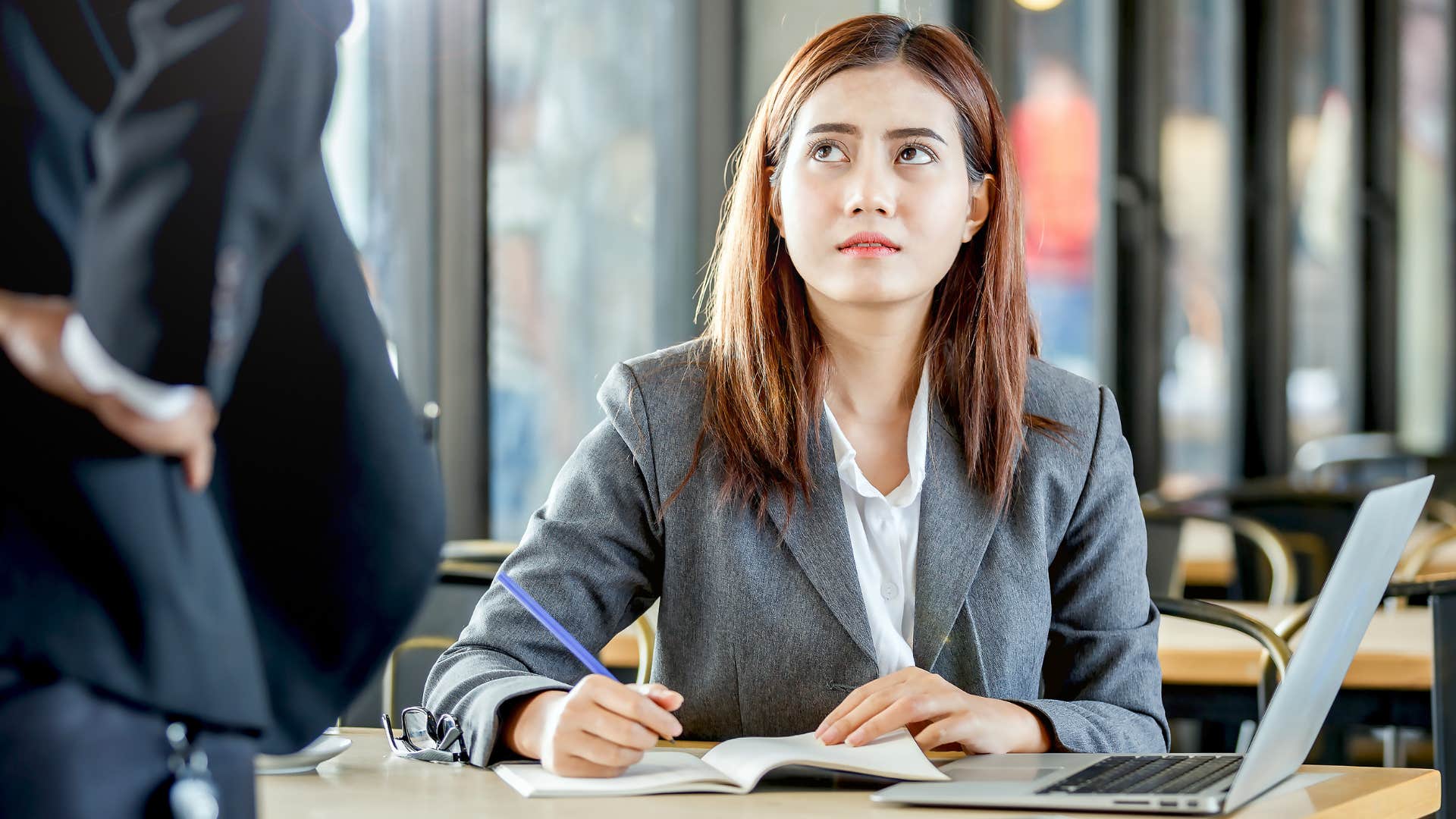 Upset woman saying "Why do you always target me?" to her boss.