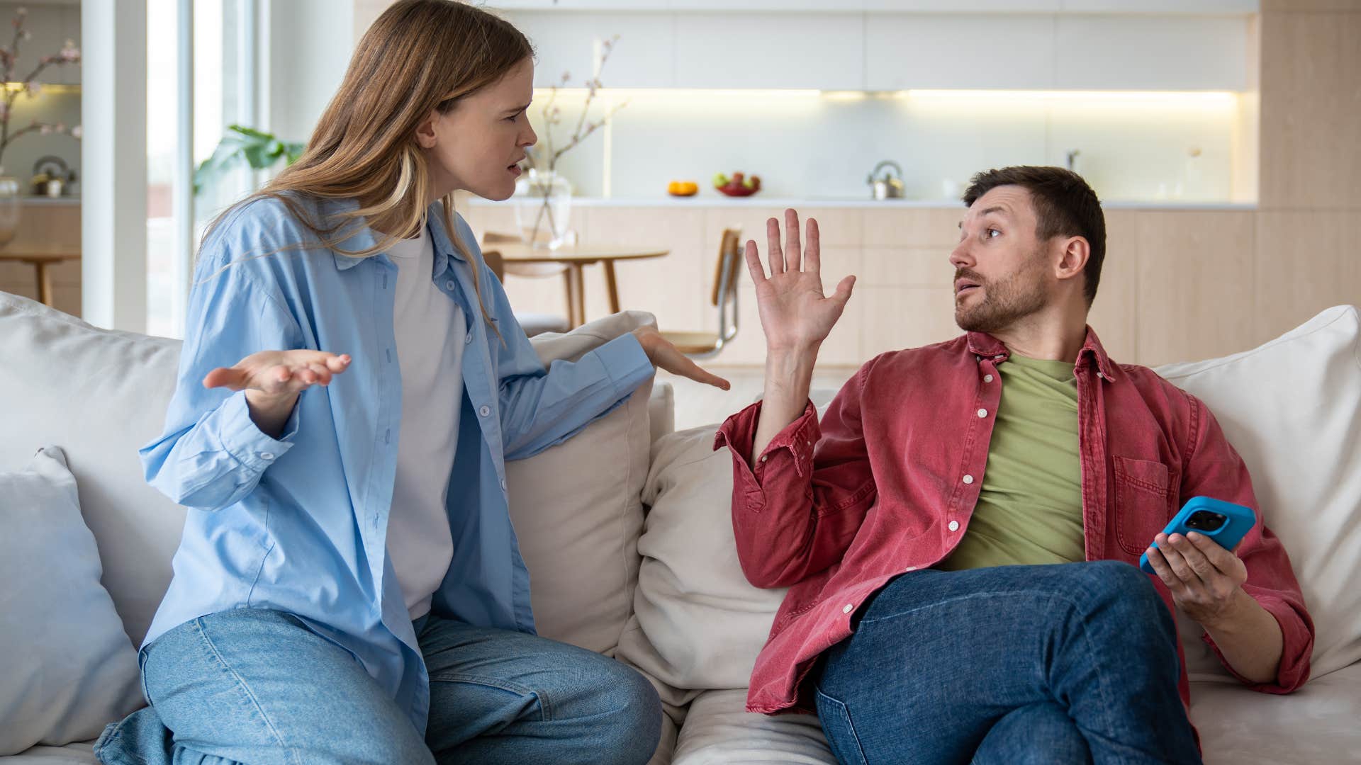 Woman saying "that's not my problem" to her husband.