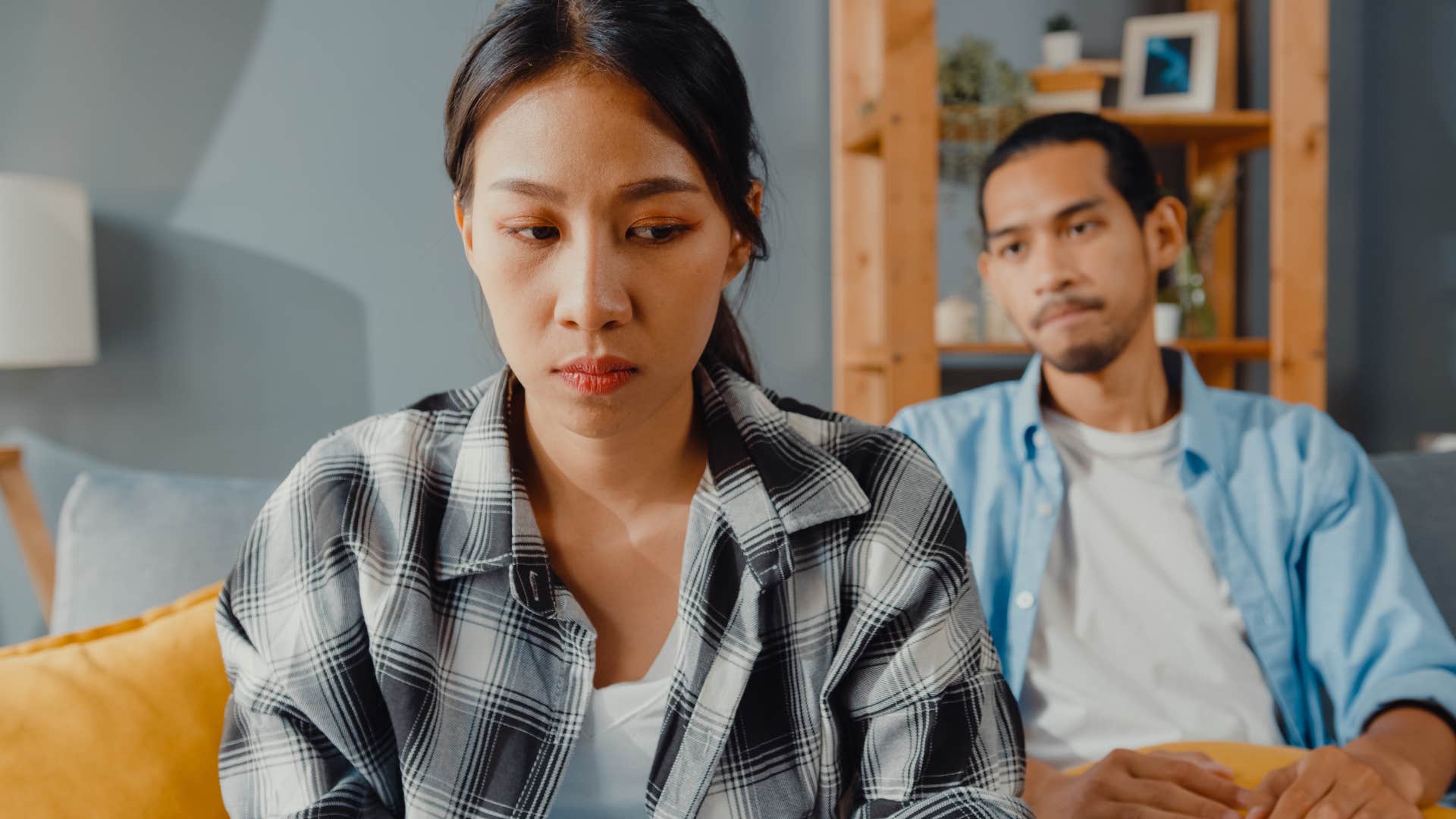 Woman turned away from her husband saying "whatever."