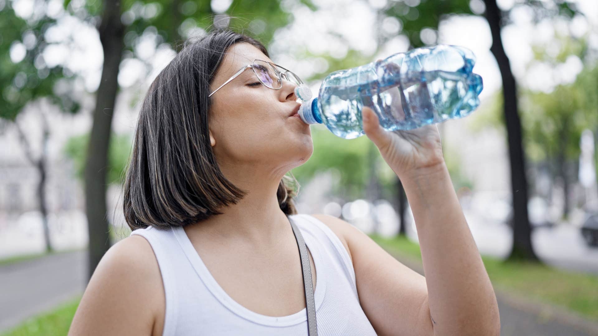 woman hydrating drinking water