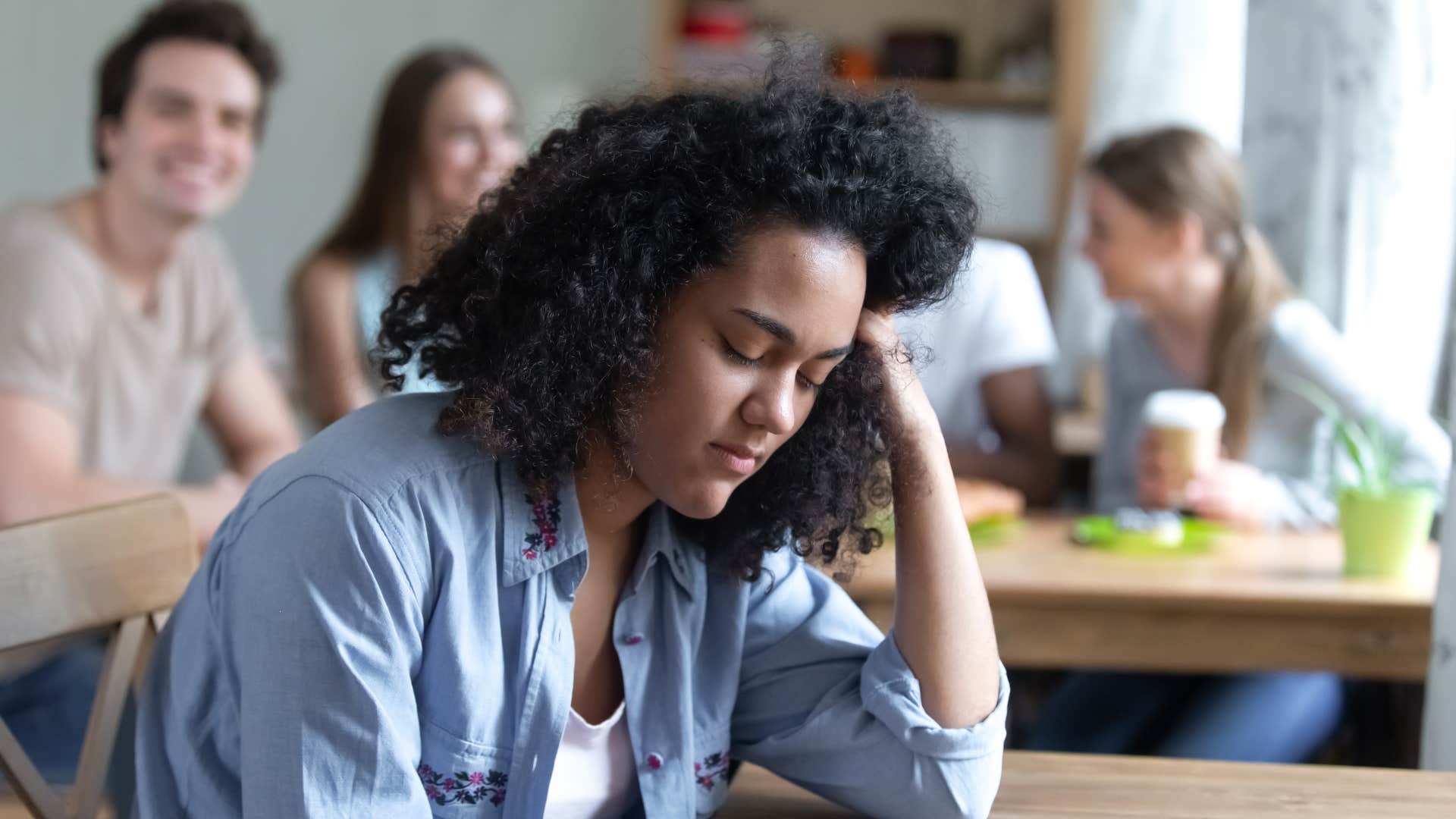 sad woman hanging out with mean friends