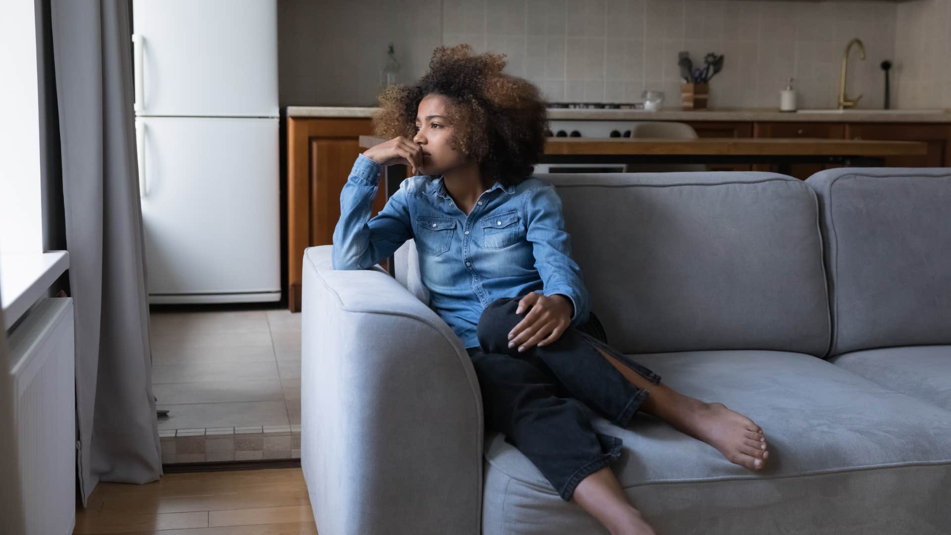 woman sitting alone at home thinking of her bad habits
