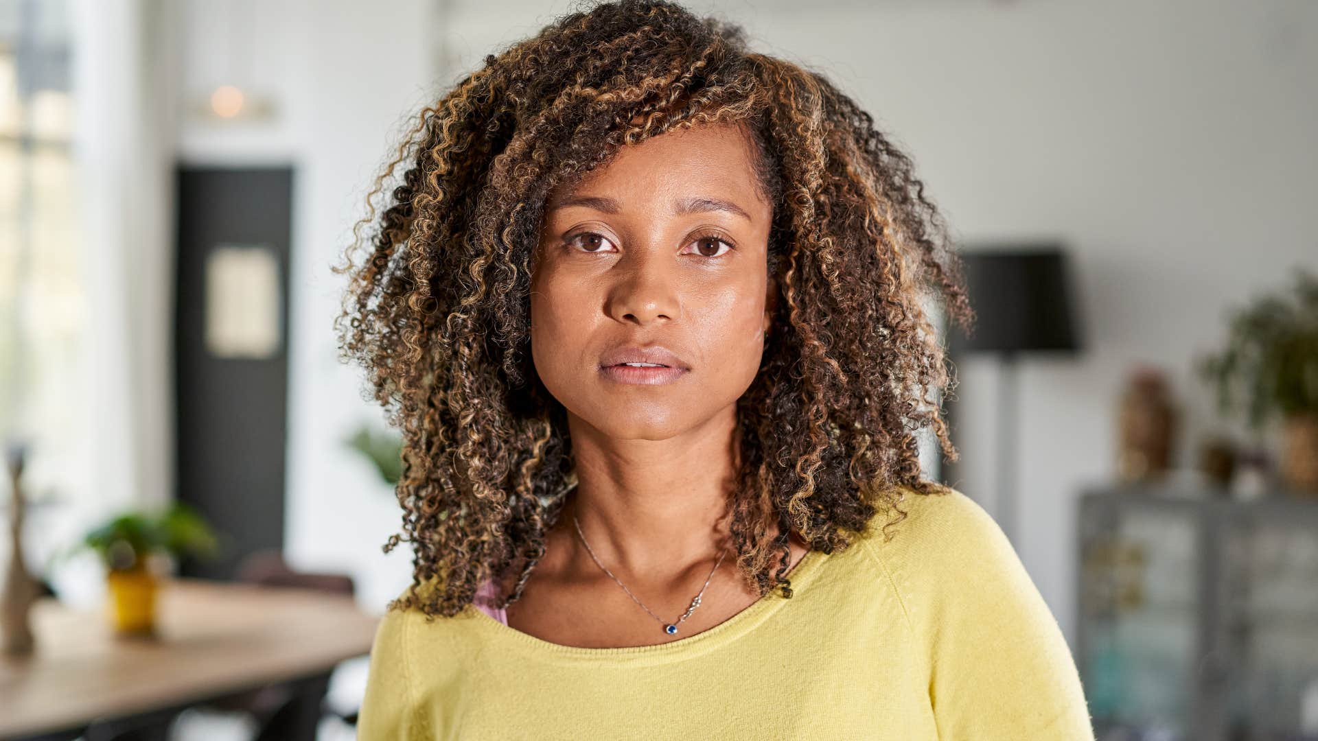 Woman who's more in control without the news looking at the camera.