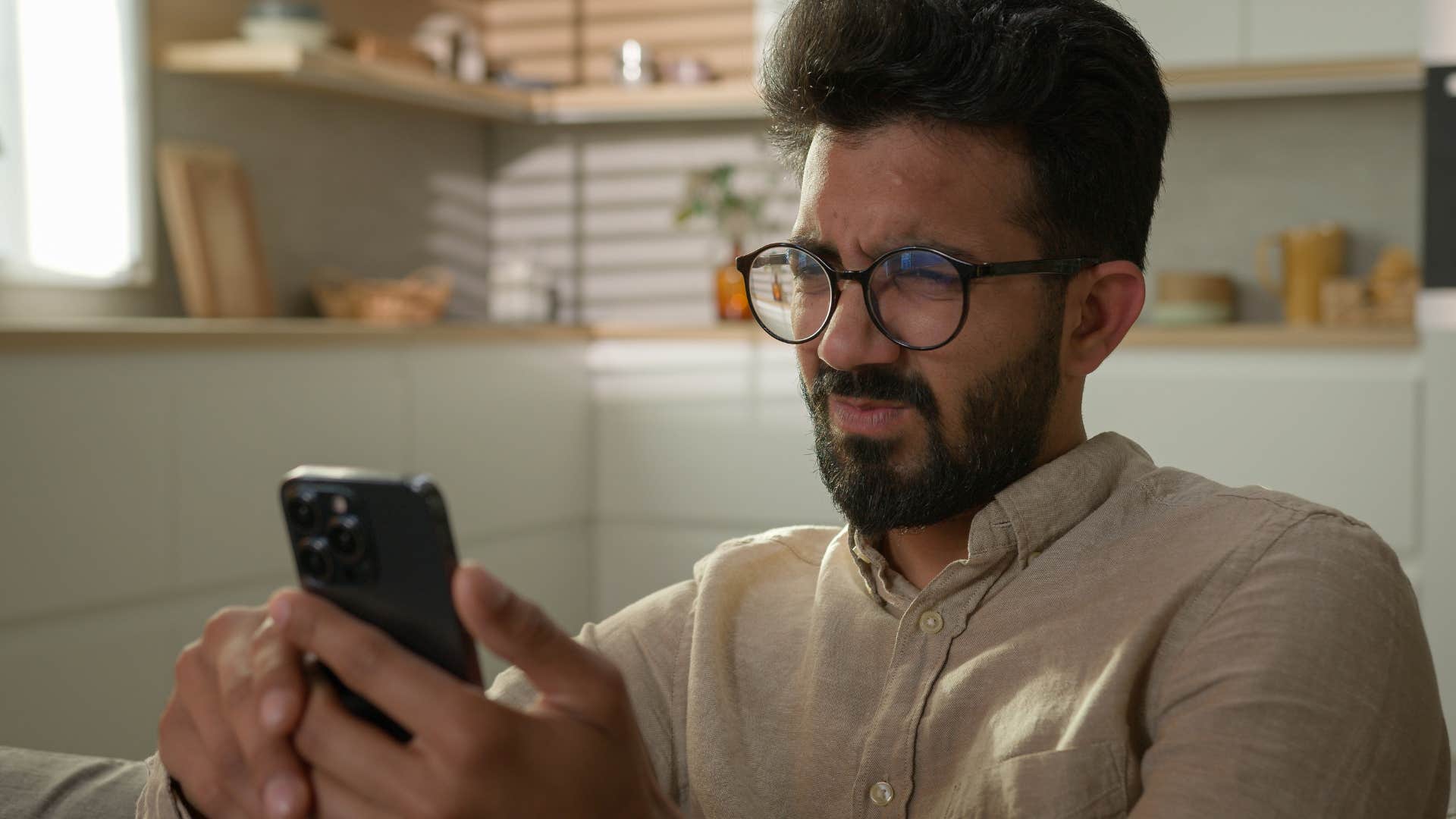 Man who feels poorly represented by the news scrolling on his phone.