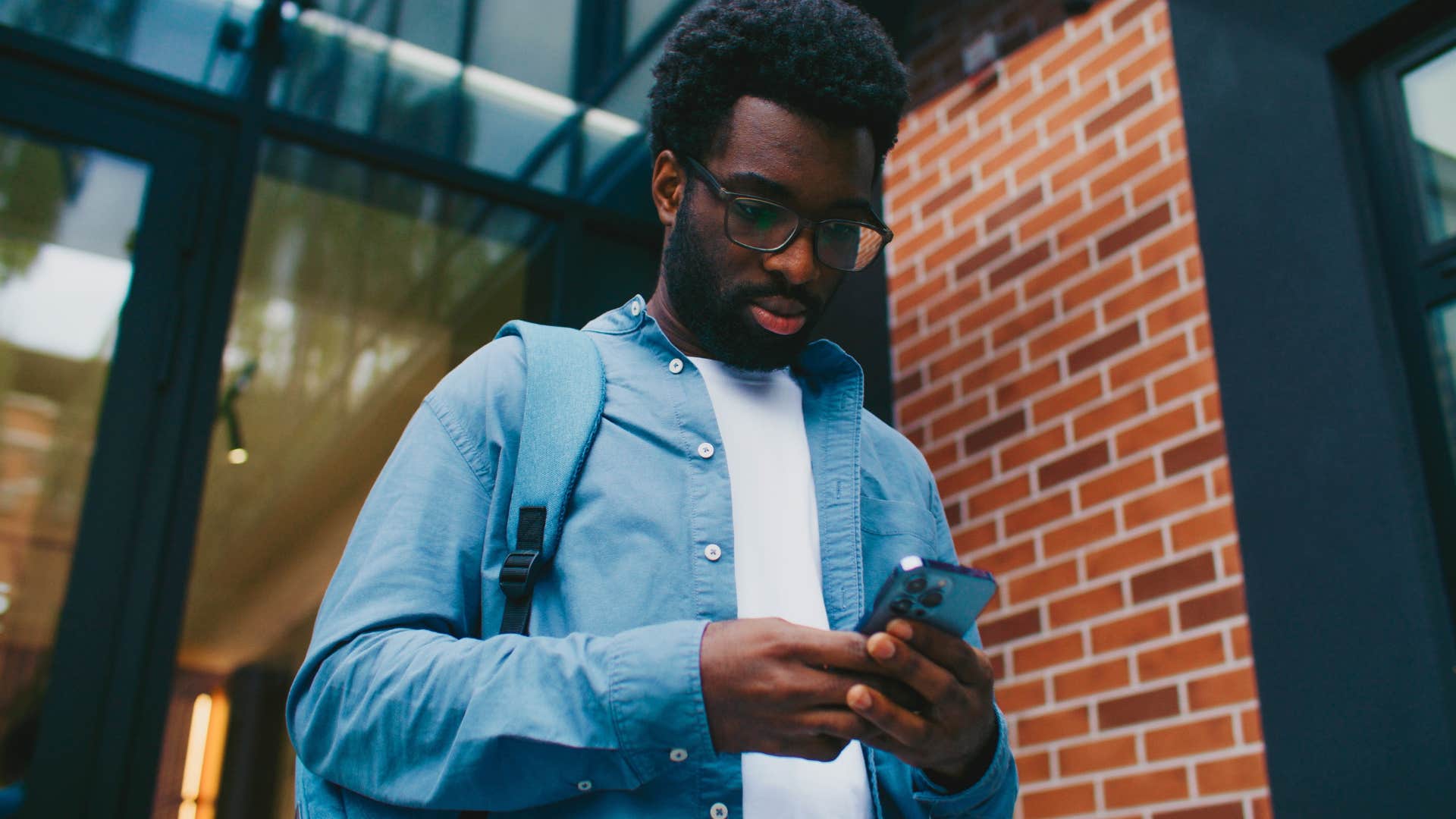 man reading news headlines scrolling on his phone