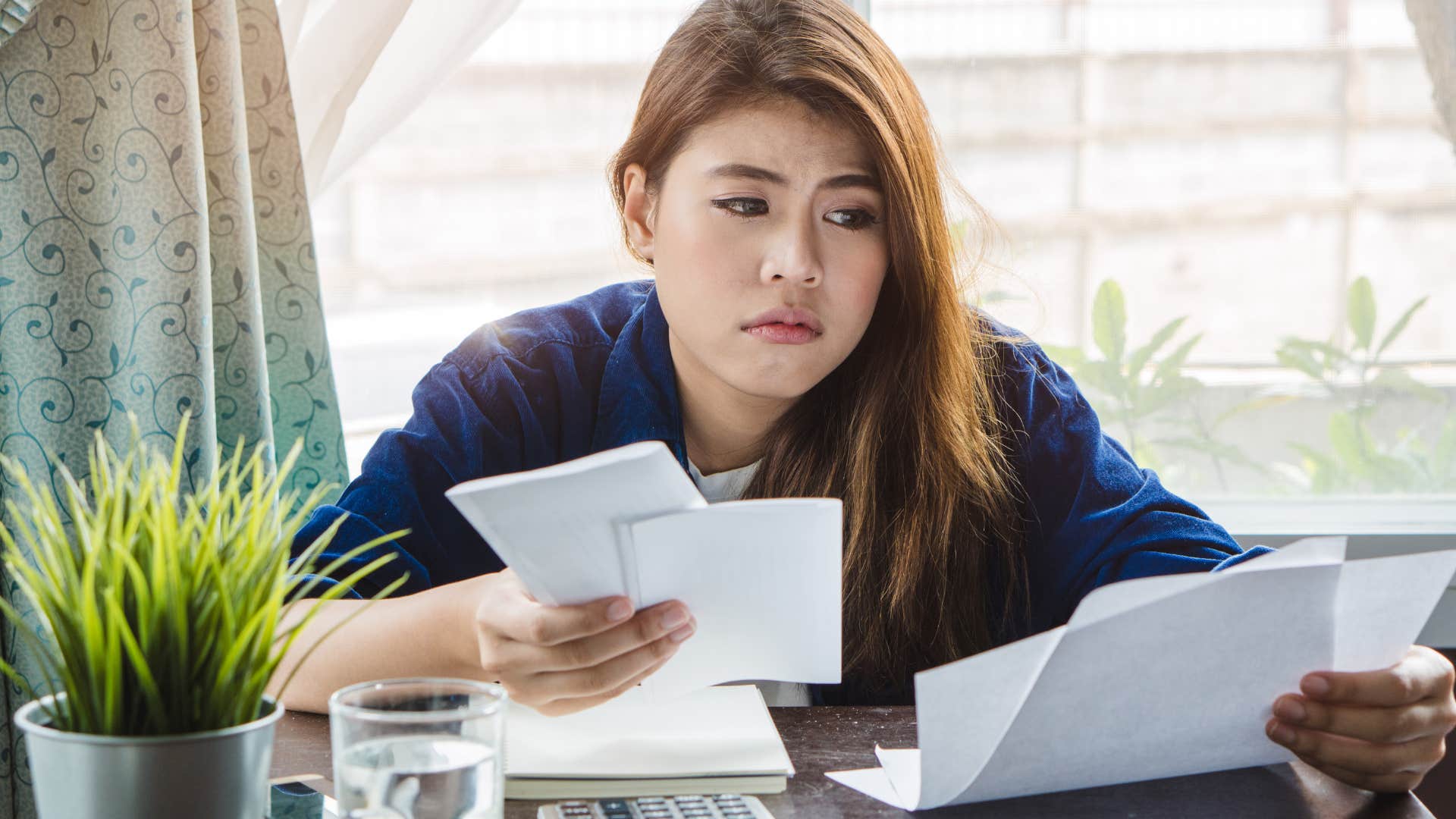 stressed woman making late payments on her credit card