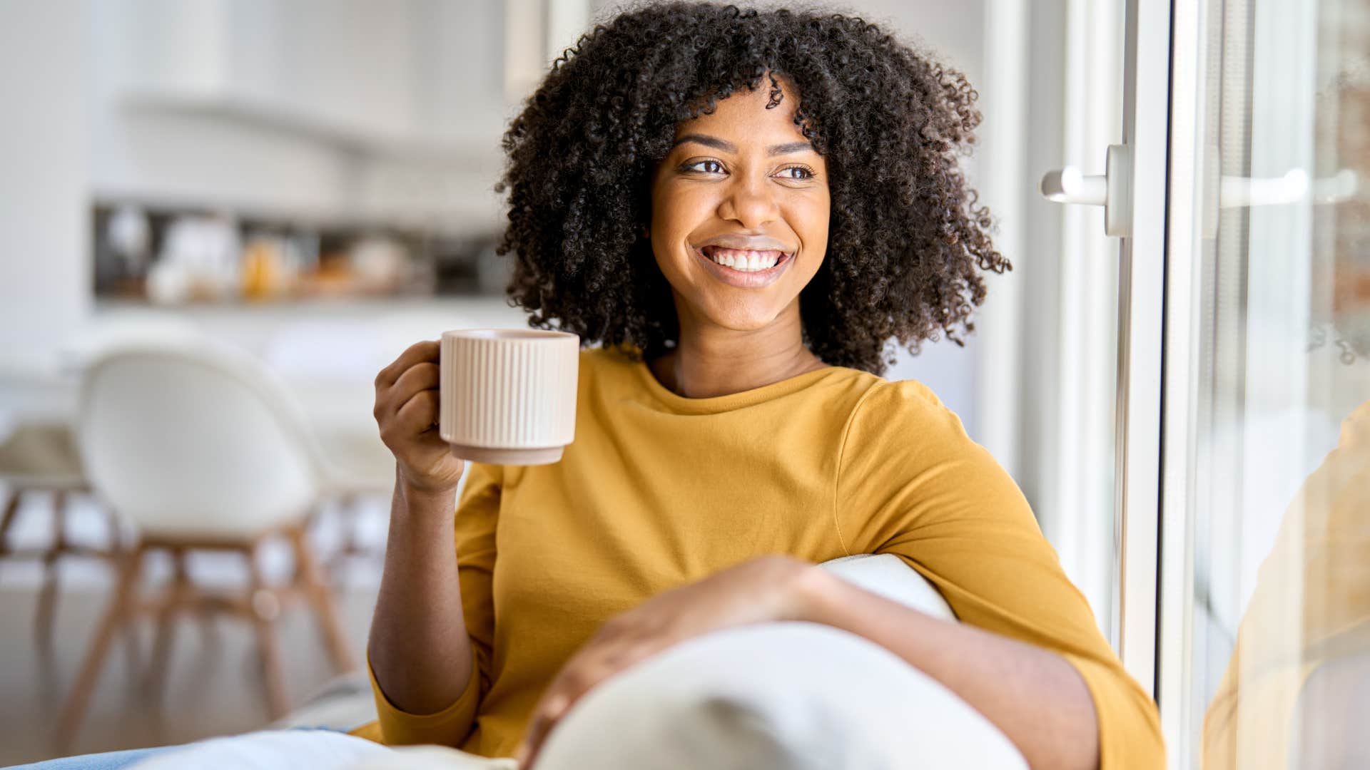 Woman sitting in the quietness of her home.