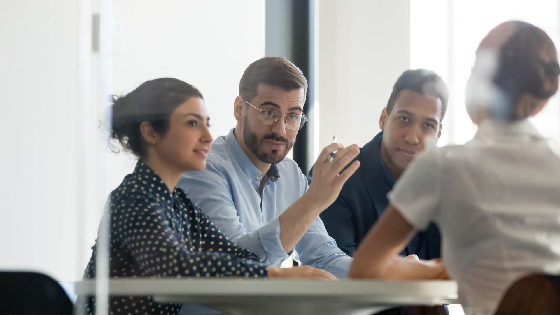happy man asking questions in work meeting