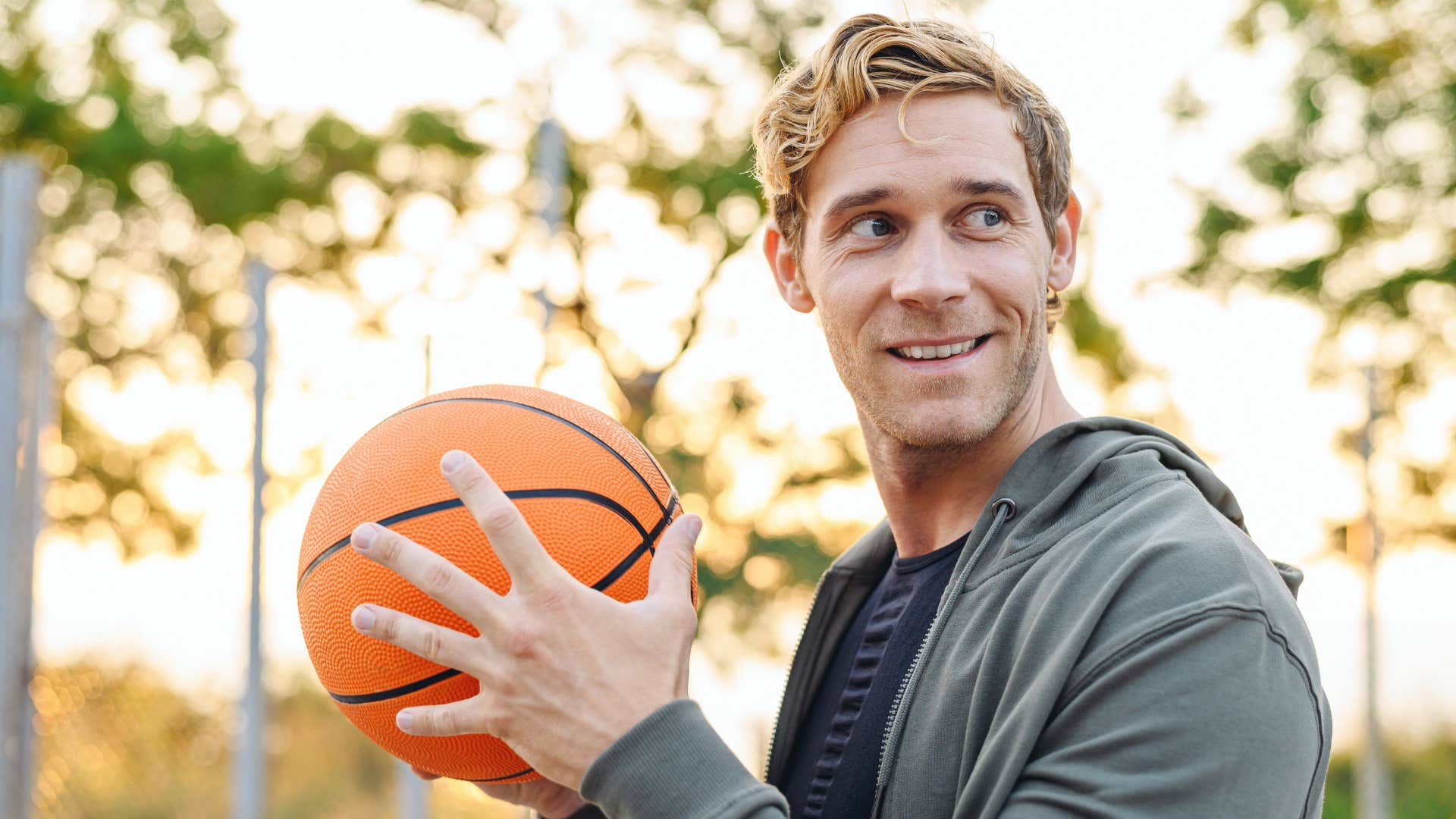 man enjoying childish activity playing basketball