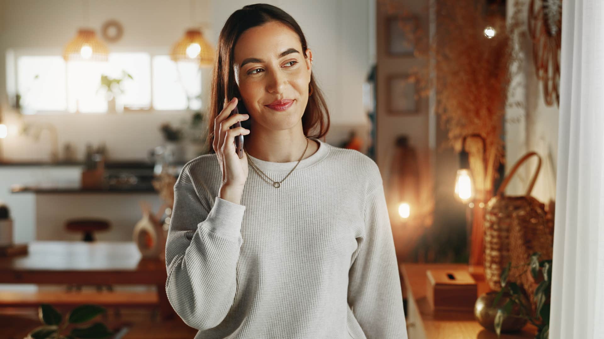 woman talking on the phone surrounded by coordinated home decor