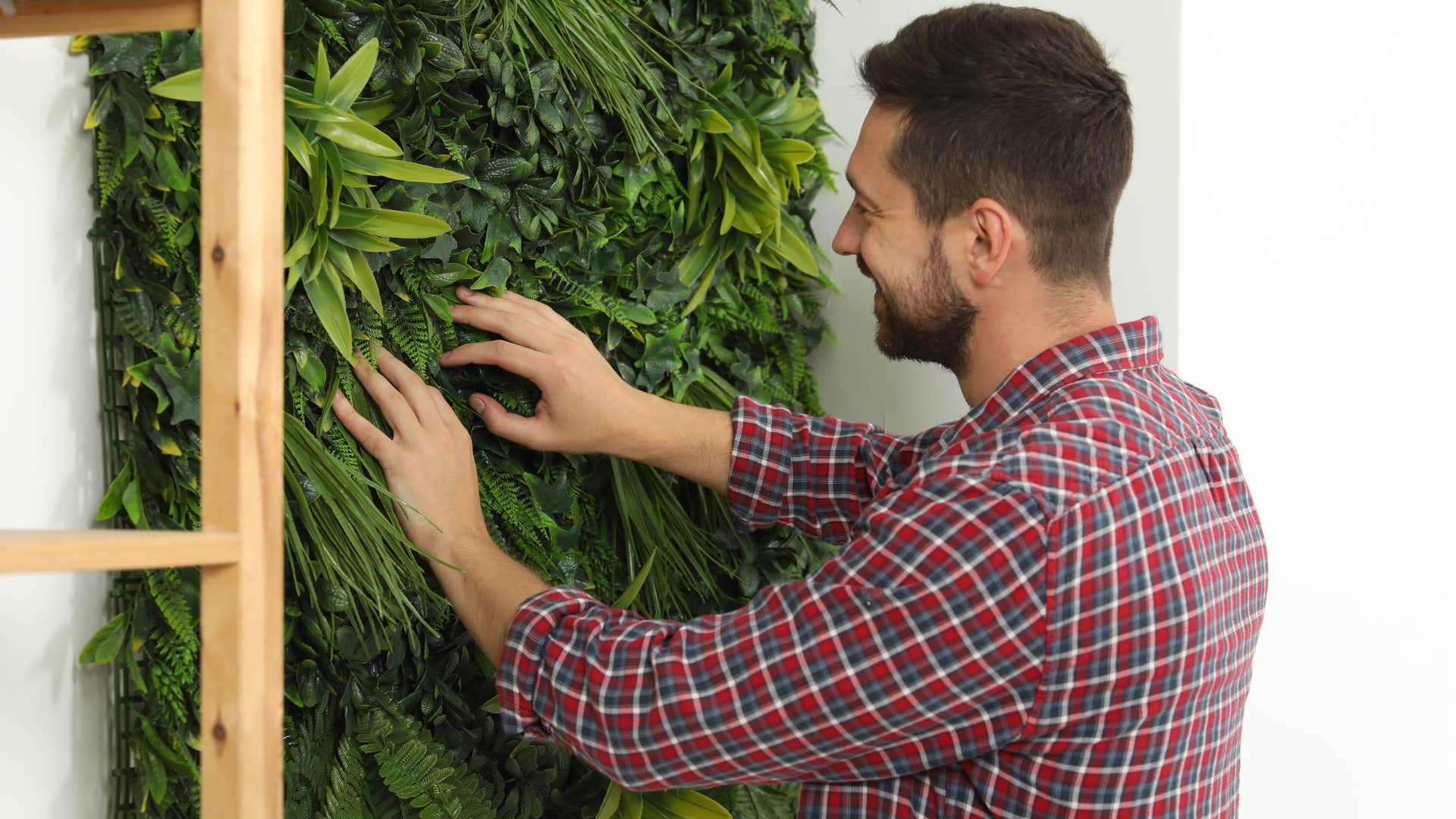man touching fake plants and flowers