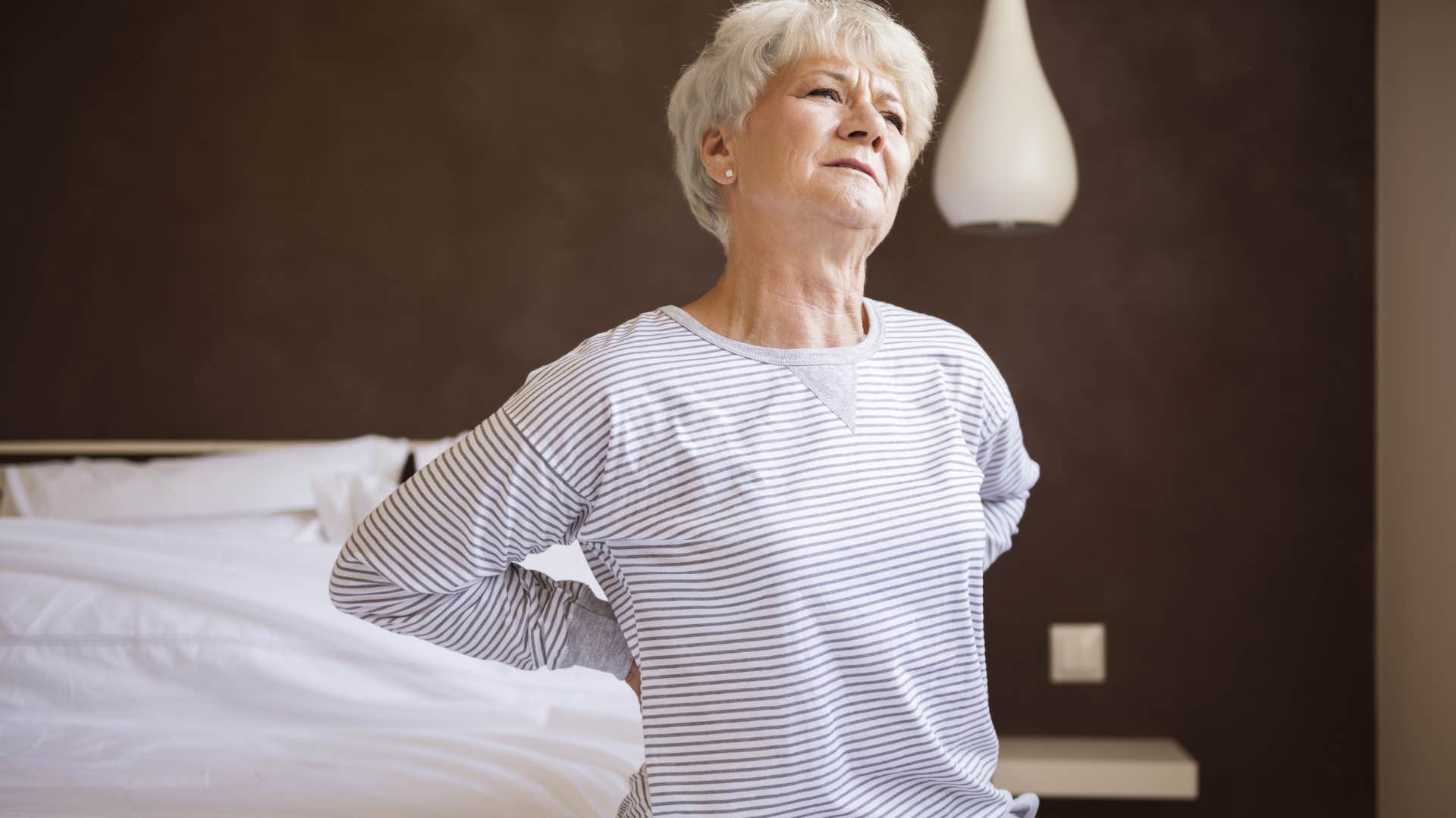 woman stretching her back after laying on mattress