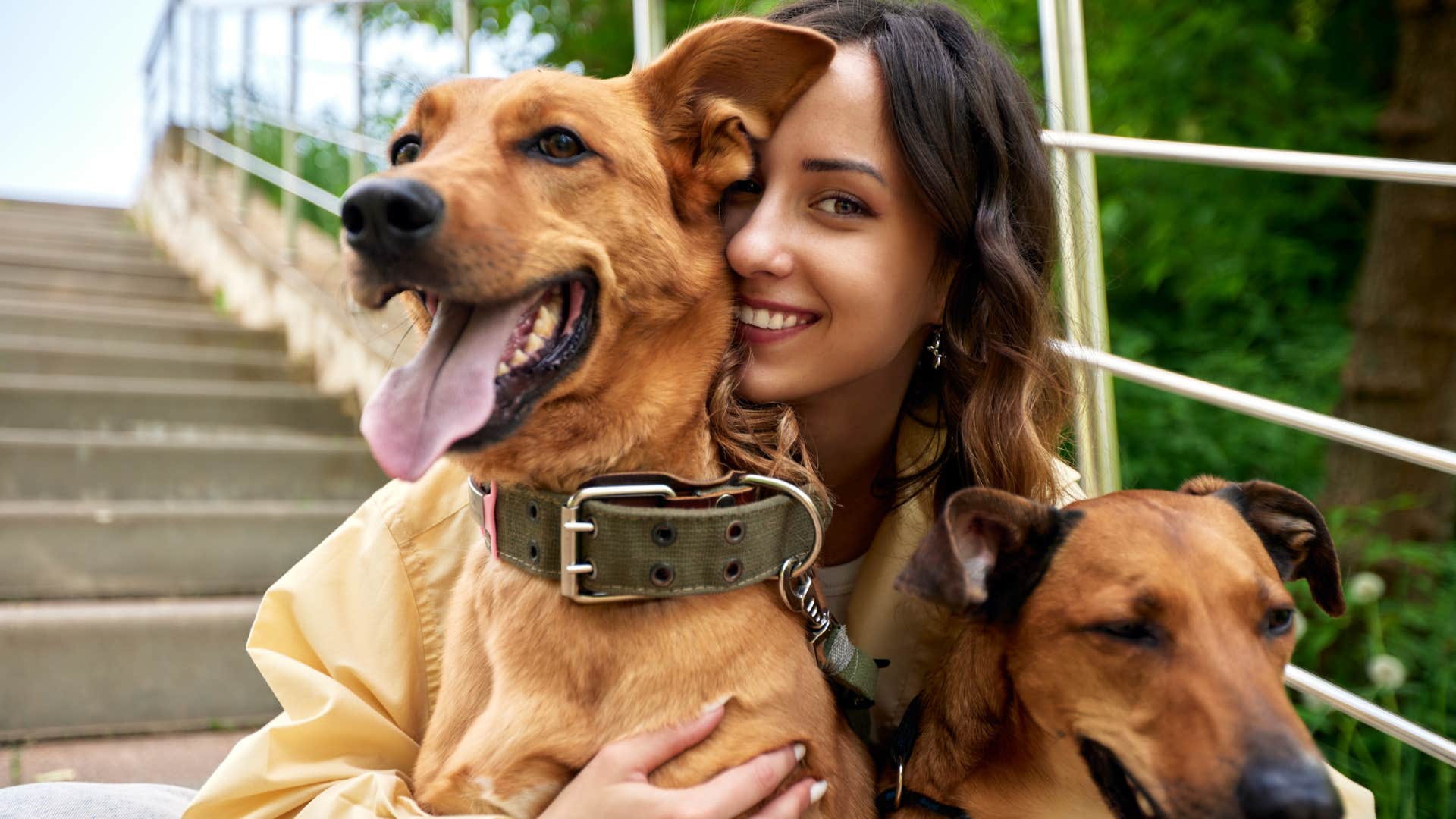 woman with no drama smiling with her dogs