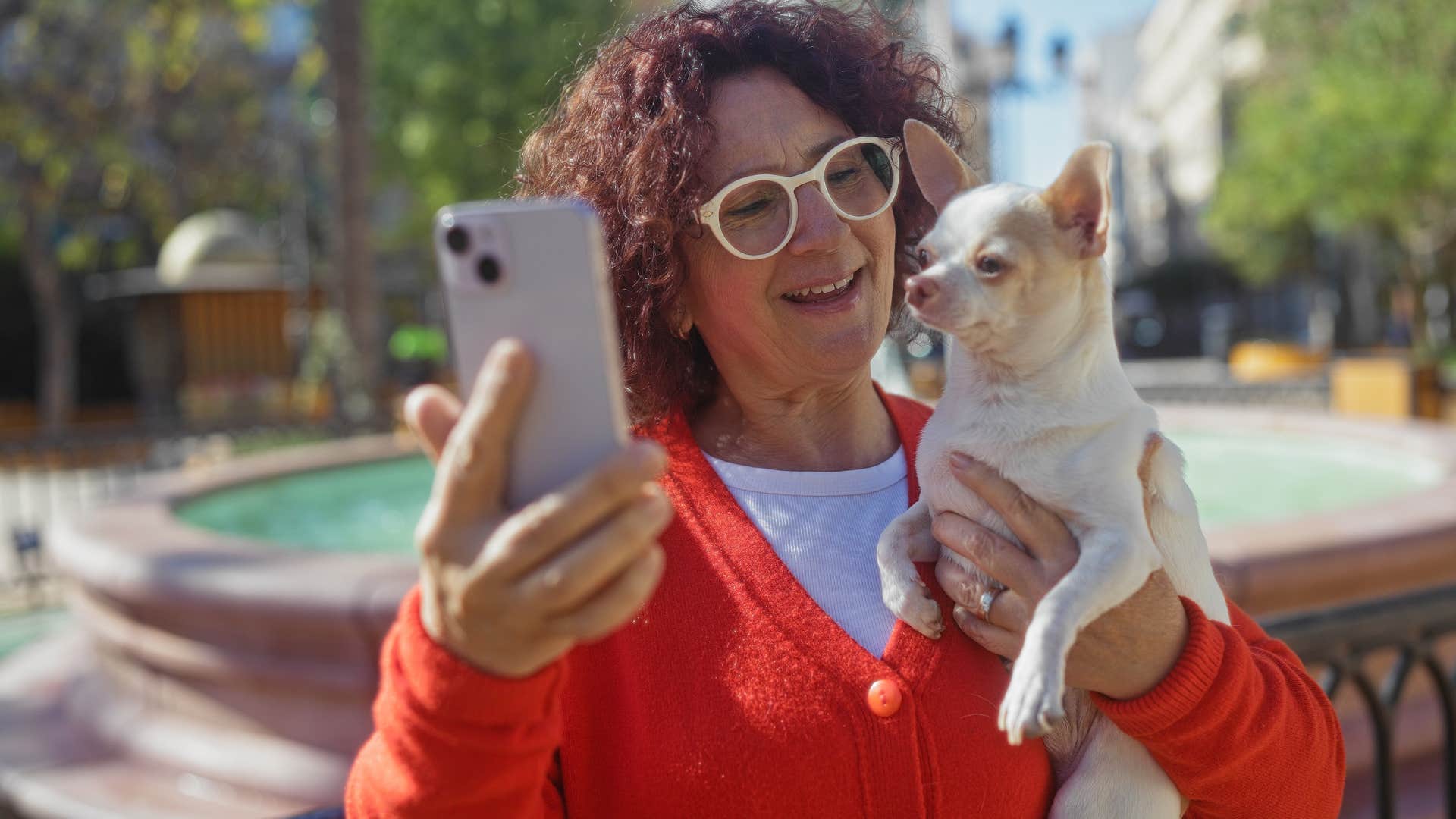 woman with a strong and secure routine taking pictures with her dog