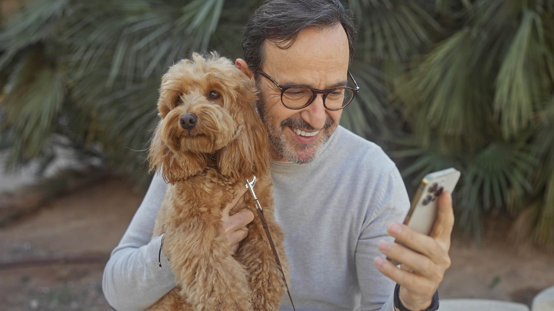 man smiling not disappointed holding his dog