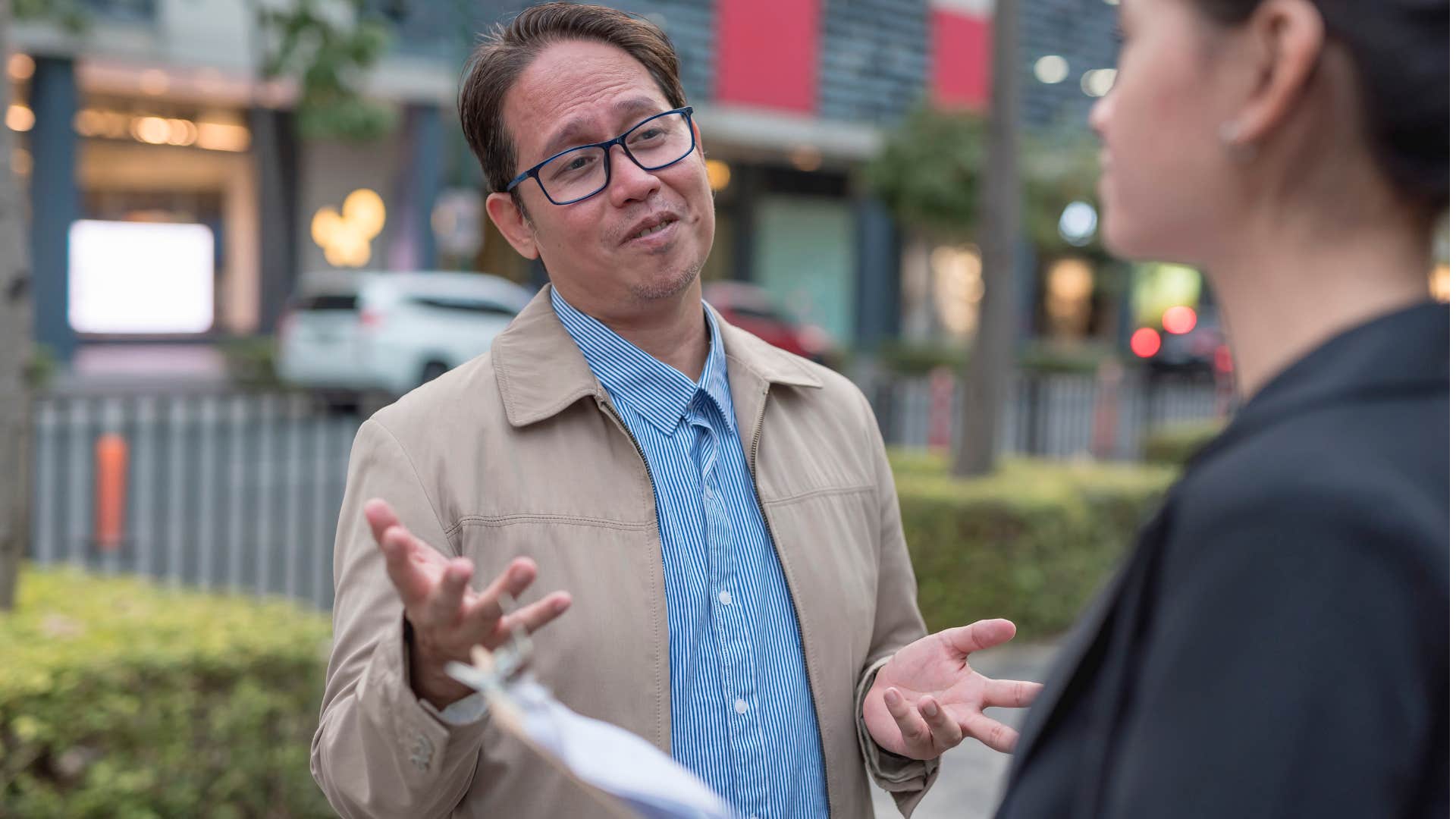 Man with overconfidence talking to a co-worker.