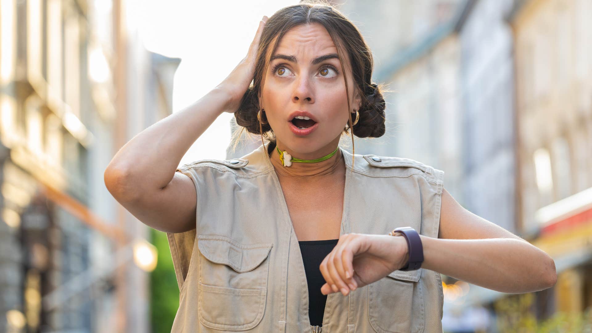 Woman showing up late and looking at her watch.
